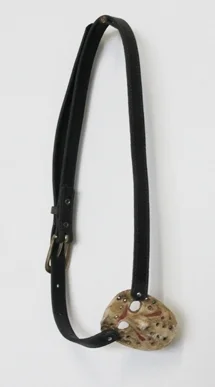 April Childers Eye Patch , 2012 Altered faux leather belt, air-dry clay, acrylic paint, rusty nail, faux metal sticker studs 11 1/2 x 6 1/2 inches $1,000 