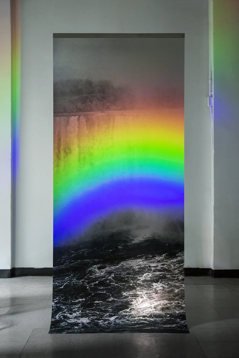 David Chan "Somewhere Else"/ Inkjet print hanging from ceiling, rainbow projection using flashlight and dvd / 40" x 96"