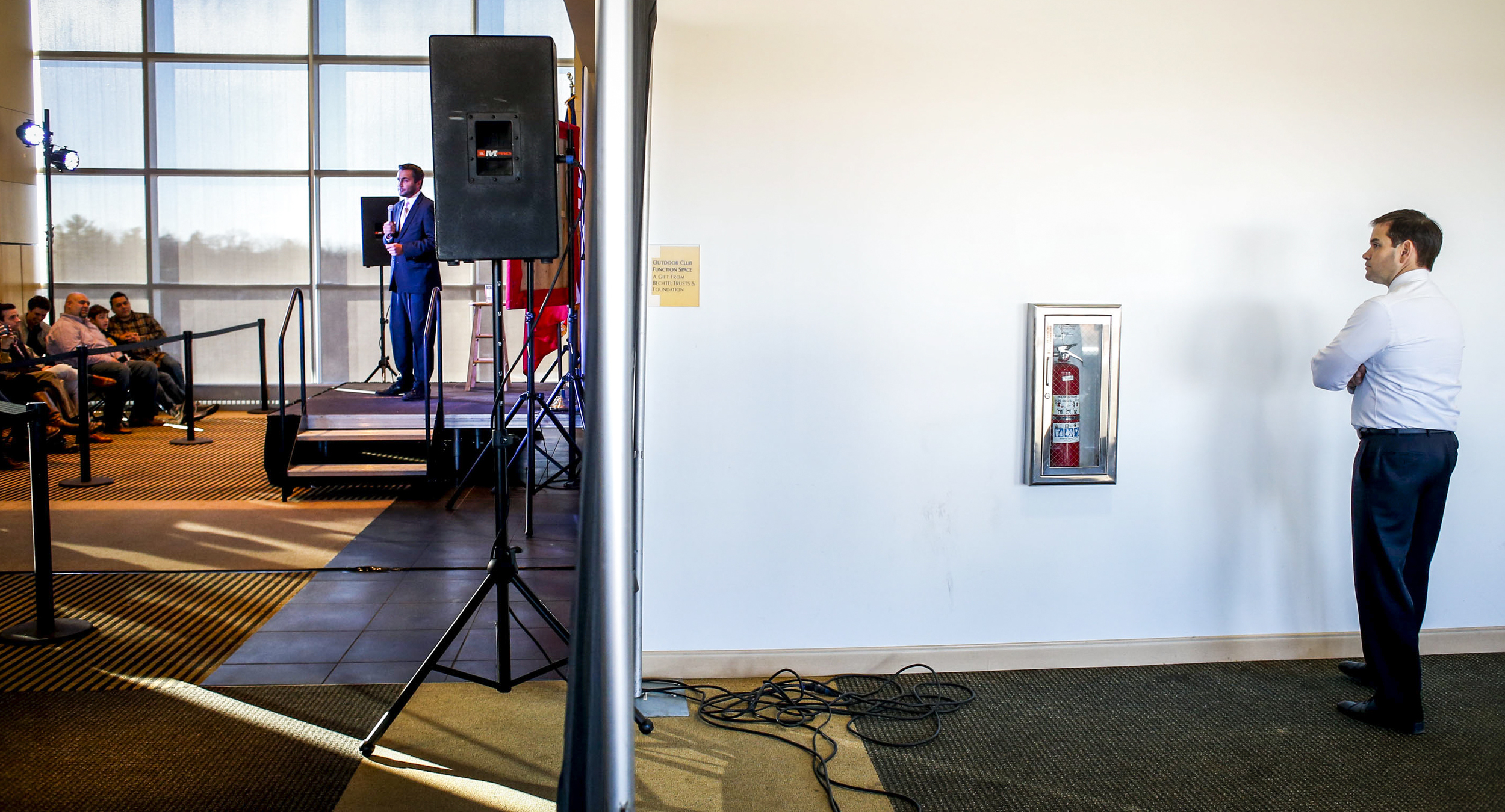 Sen. Marco Rubio stands behind a curtain preparing to speak while Iowa State Rep. Bobby Kaufmann presents him to the crowd at the Mediacom Outdoor Club in Kinnick Stadium in Iowa City, Thursday, Dec. 10, 2015. The republican presidential hopeful made a stop in Iowa City for a meet and greet after visiting Des Moines, Iowa, and Ames, Iowa, earlier in the day.