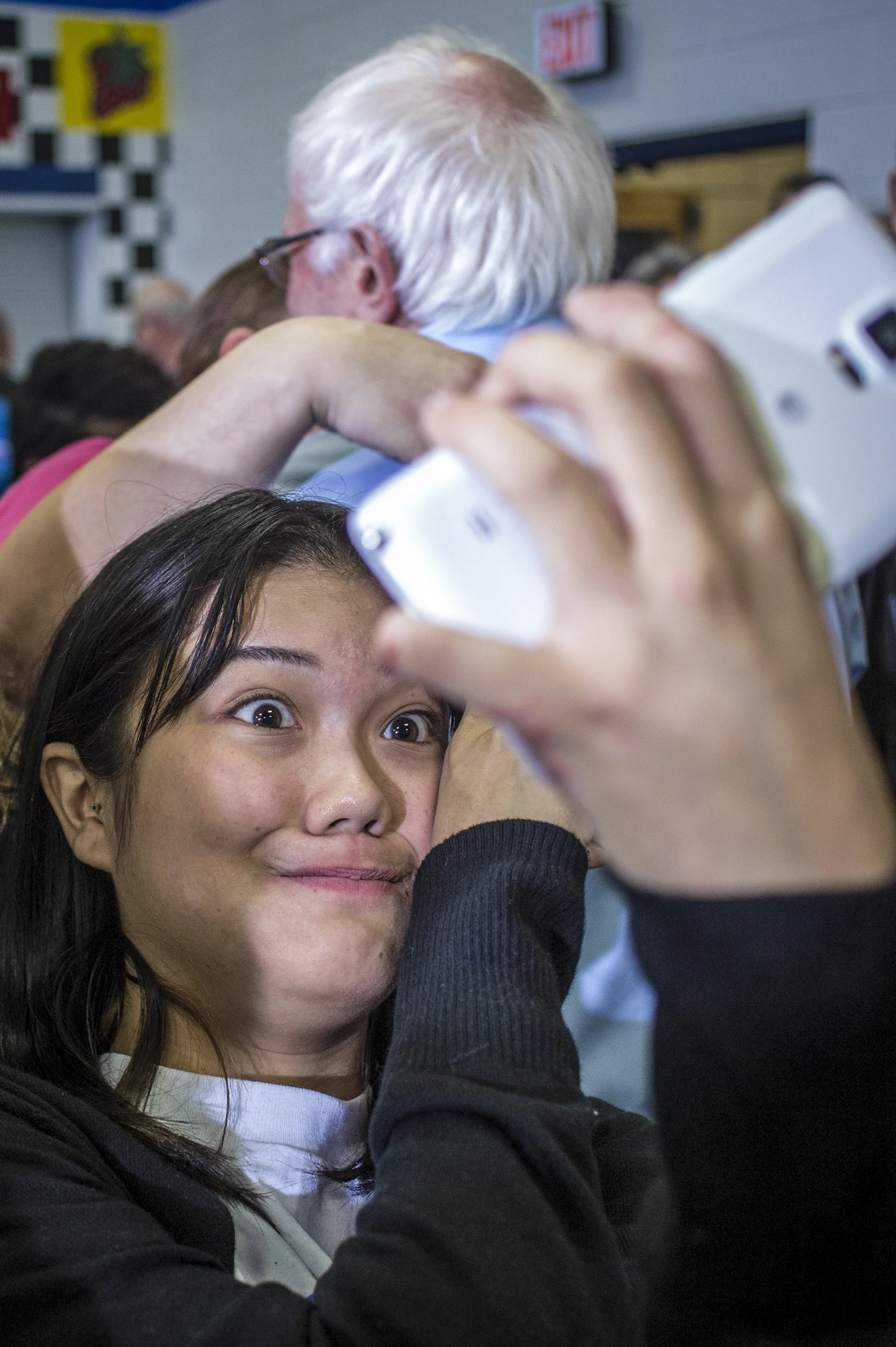 Linn-Mar junior Angel Trachta, 16, takes a selfie behind presidential hopeful Bernie Sanders after a campaign stop at Strawberry Hill Elementary in Anamosa, Iowa, Saturday, Dec. 12, 2015. Vermont Sen. Bernie Sanders made a campaign stop in Anamosa to hold a forum on racial justice and prison reform.