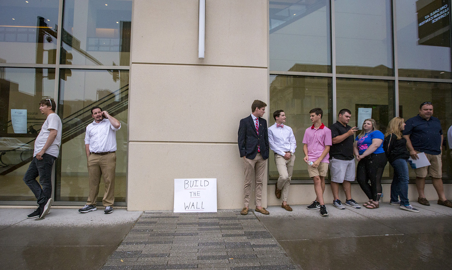 Attendees wait in line outside the U.S. Cellular Center in Cedar Rapids to hear President Donald Trump speak at a campaign rally, Wednesday, June 21, 2017.