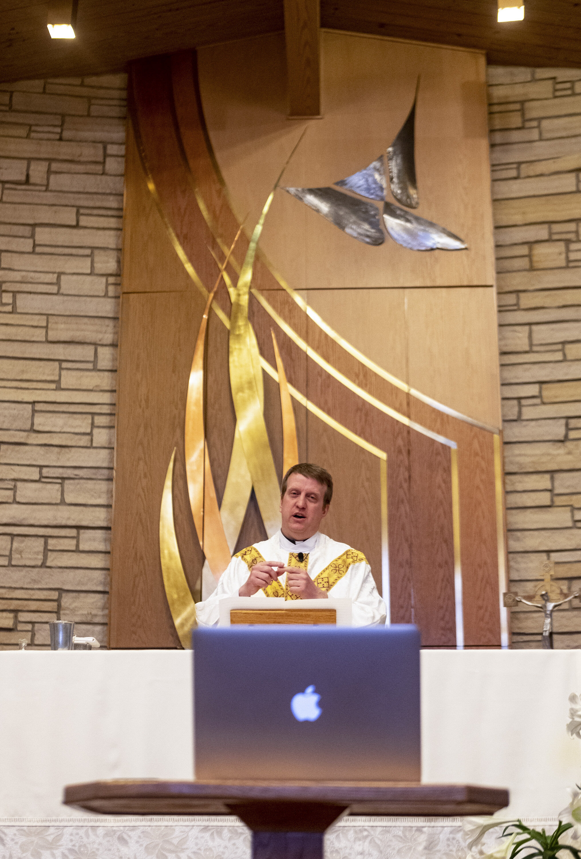  Rev. Mark Murphy leads mass as it is live-streamed at St. Jude’s Catholic Church in Cedar Rapids on Saturday.  