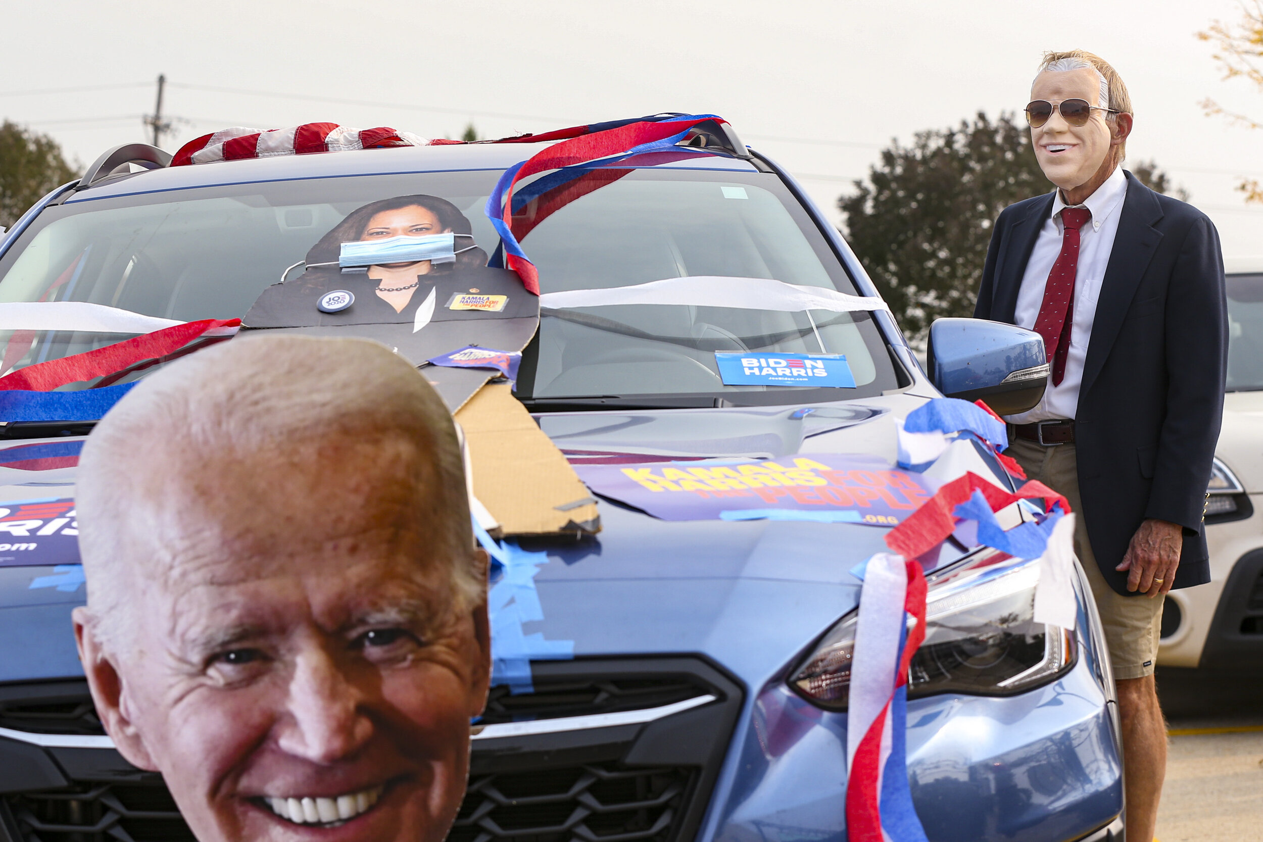  David Kutter of Cedar Rapids stands by his vehicle wearing a Joe Biden mask while waiting to hear former second lady Jill Biden speak during a drive-in rally at Kirkwood Community College in Cedar Rapids, Iowa, Saturday. 