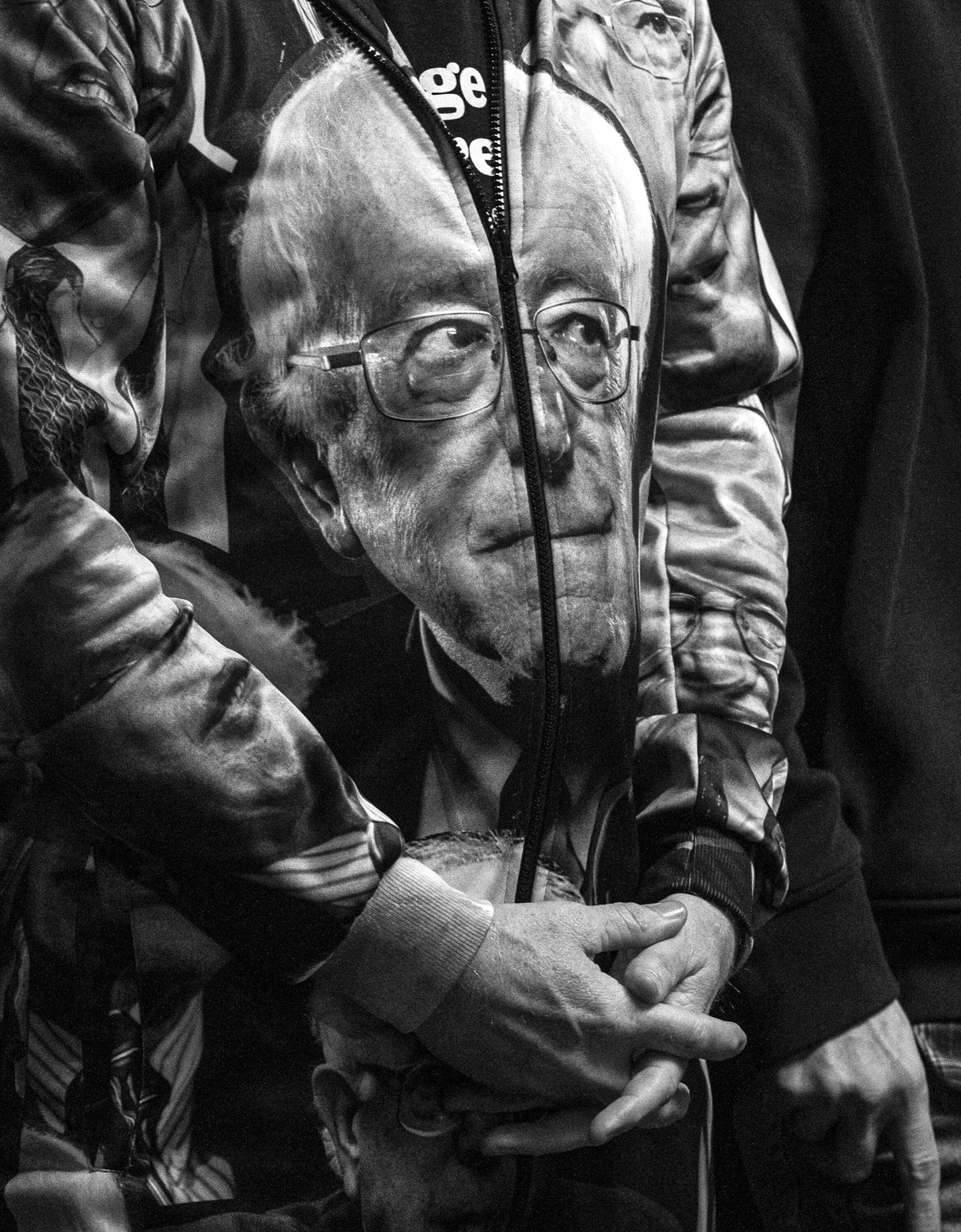  Keith Anthony Sikora of Los Angeles stands wearing a Sen. Bernie Sanders jumpsuit as he listens to Rep. Alexandria Ocasio-Cortez give a speech in support of the Sanders campaign at the Cedar Rapids, Iowa, field office on Saturday.  