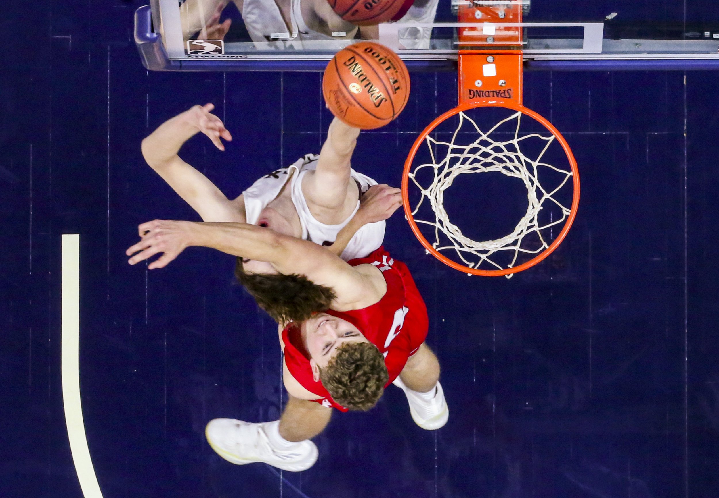 North Linn's Tate Haughenbury (30) shoots as he’s struck by South Winneshiek's Trey Kriener (23) during the fourth quarter of their 1A quarterfinal game at Wells Fargo Arena in Des Moines, Iowa, on Monday.