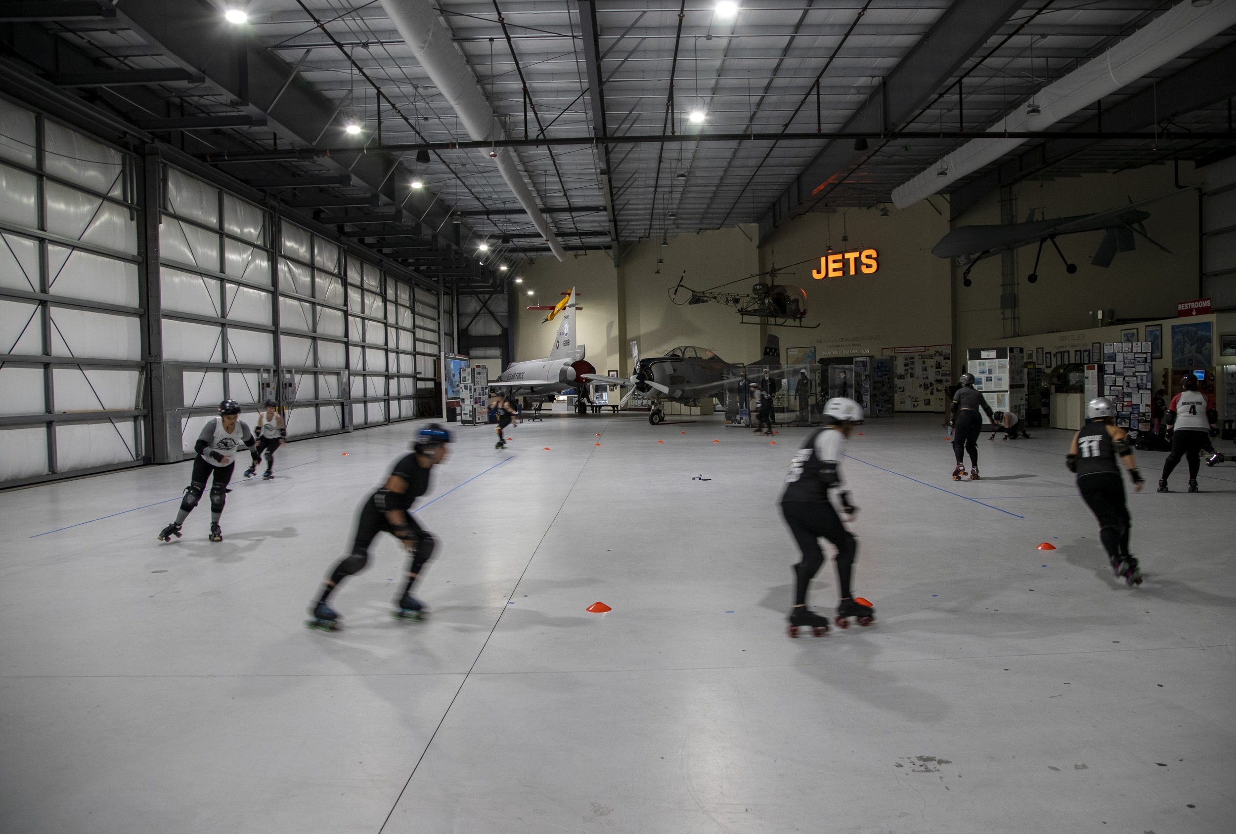  Skaters take laps to warm up before their practice at the Palm Springs Air Museum in Palm Springs, Calif., Monday. The team was practicing for the first time in their new home venue where they would soon be hosting their homecoming game.  