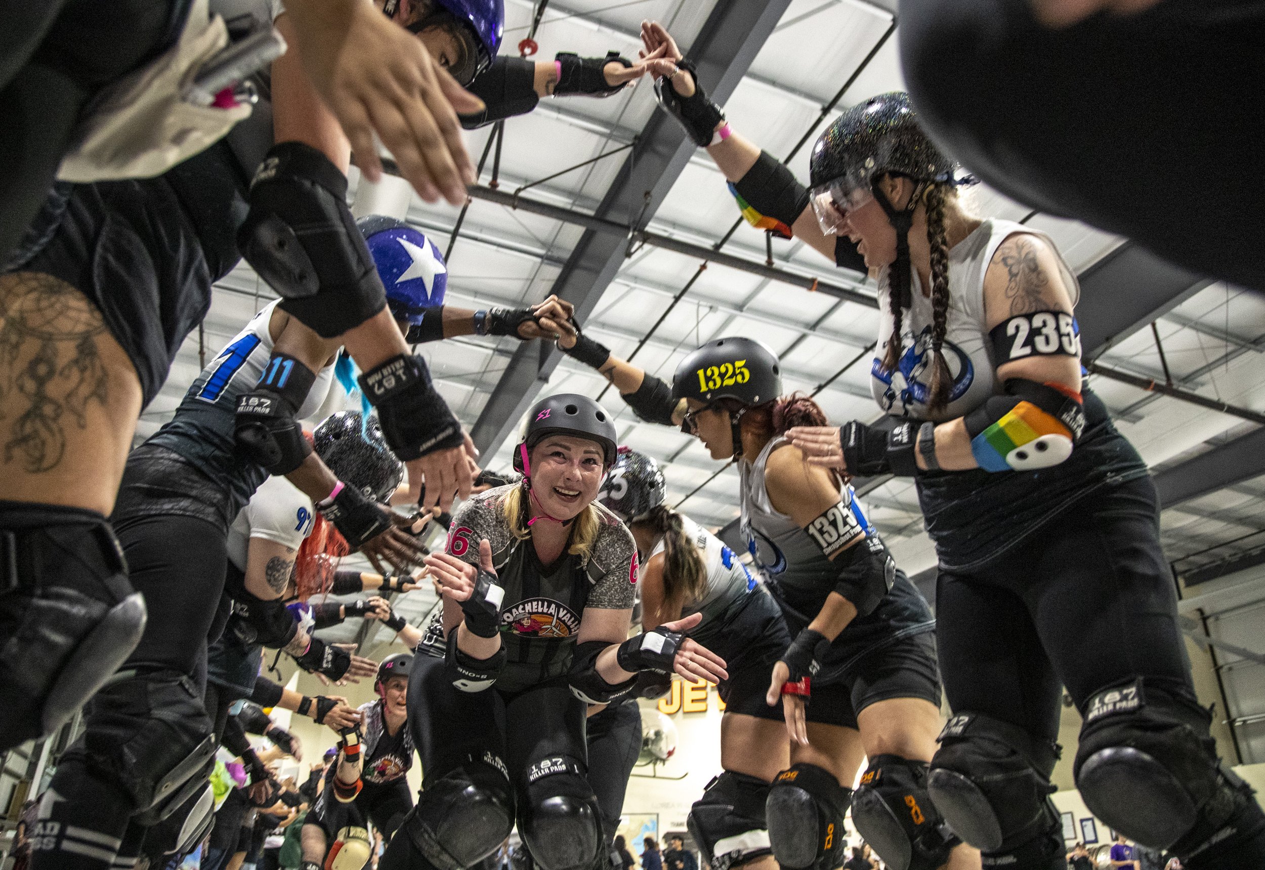  Victoria Villarreal skates through a tunnel of players from their opponent, Infinity Roller Derby, after their homecoming bout at the Palm Springs Air Museum in Palm Springs, Calif., Saturday. Coachella Valley lost the game 213-189 but called it a s