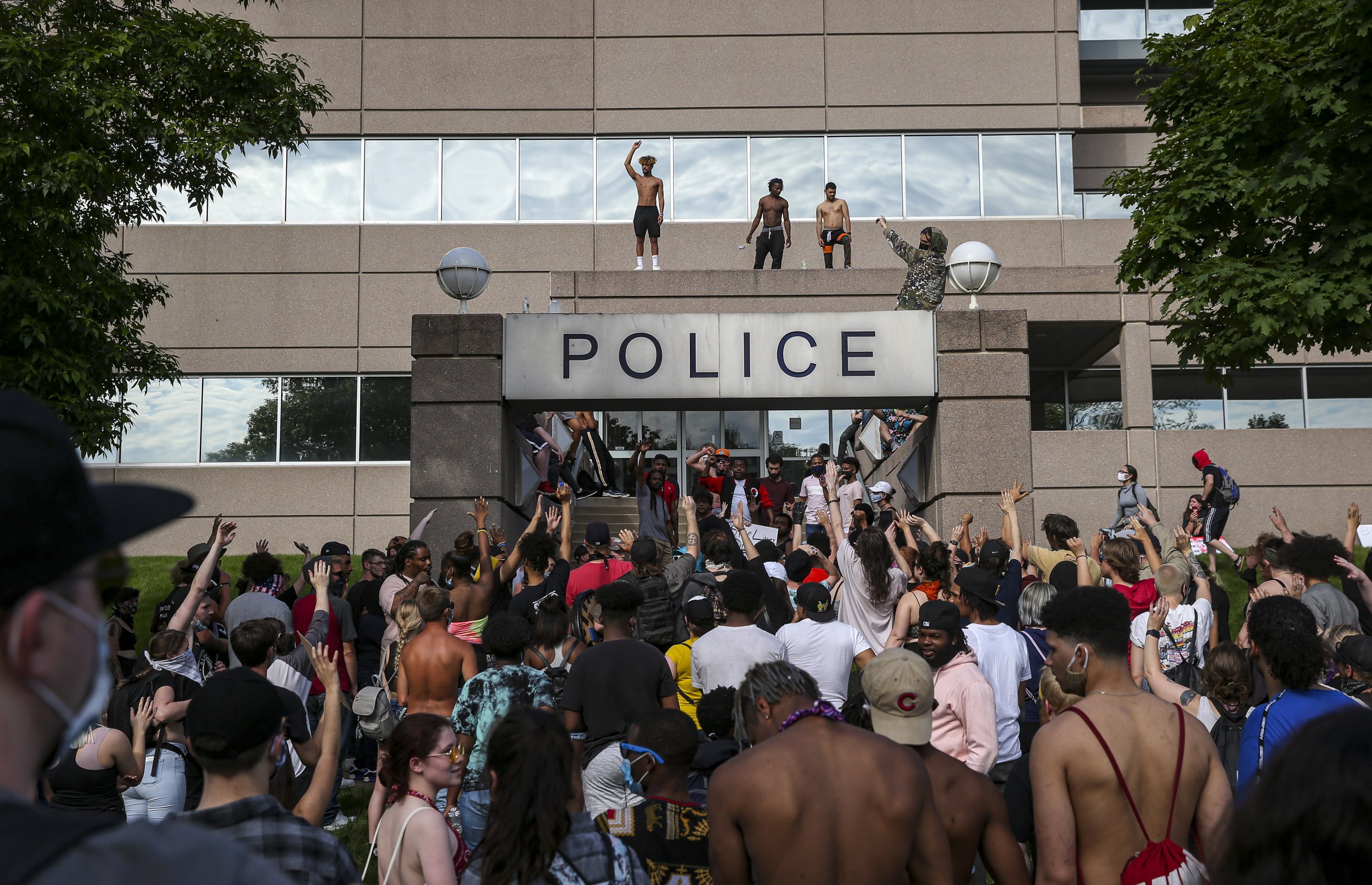  Protestors gather at the Cedar Rapids police station after marching around SE Cedar Rapids on Sunday.  