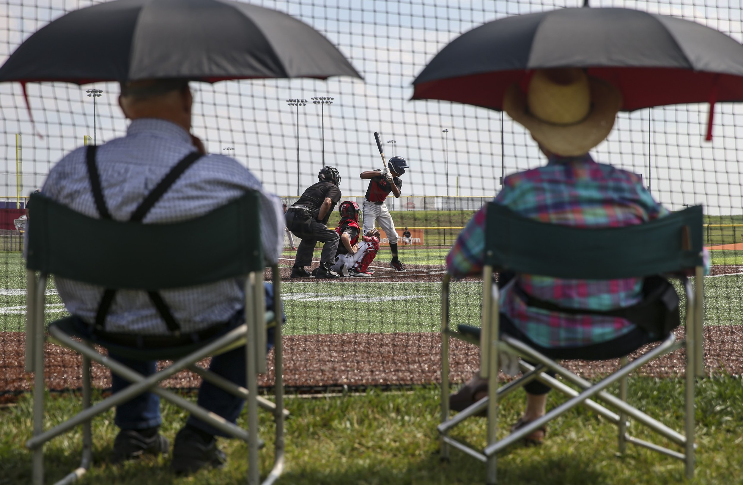  Fans watch a game from behind home plate as a batter awaits a pitch at Prospect Meadows in Marion on Friday. 