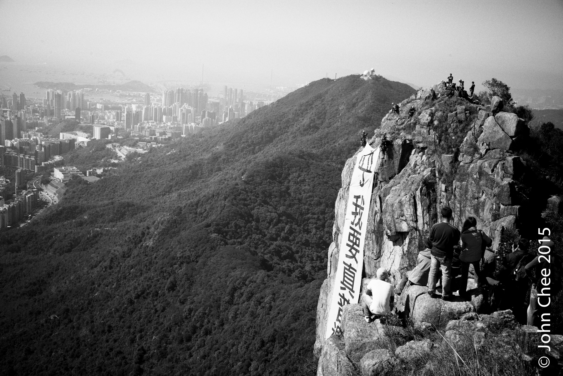 A view from the top of the Lion Rock Mountain, where an enormous banner was hung to express the wish for having a genuine universal suffrage. The government deemed the hanging of such banner is illegal, and thus it was removed within a day. Similar banners on the same spot were hung and removed at least two times subsequently. (Lion Rock, Hong Kong)