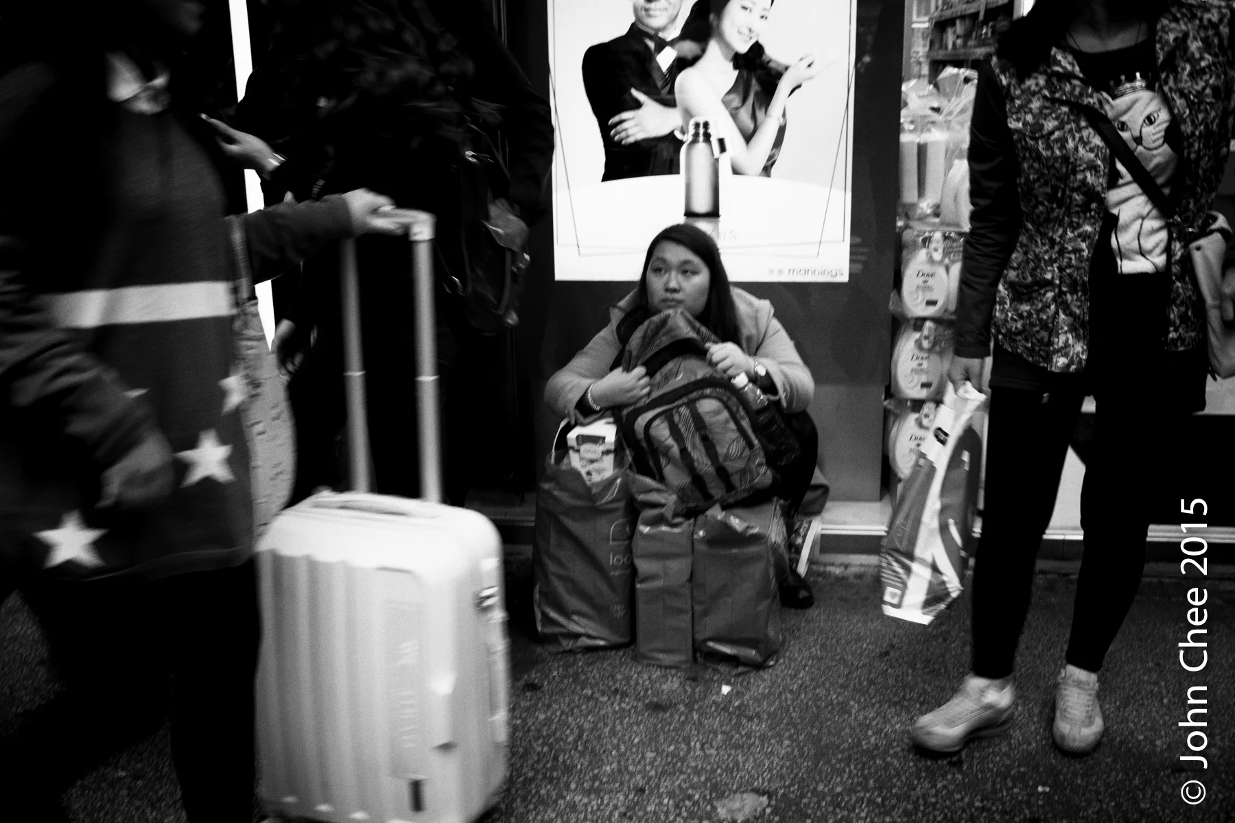 A smuggler (with her goods) waiting in front of a drug store (Mong Kok, Hong Kong)