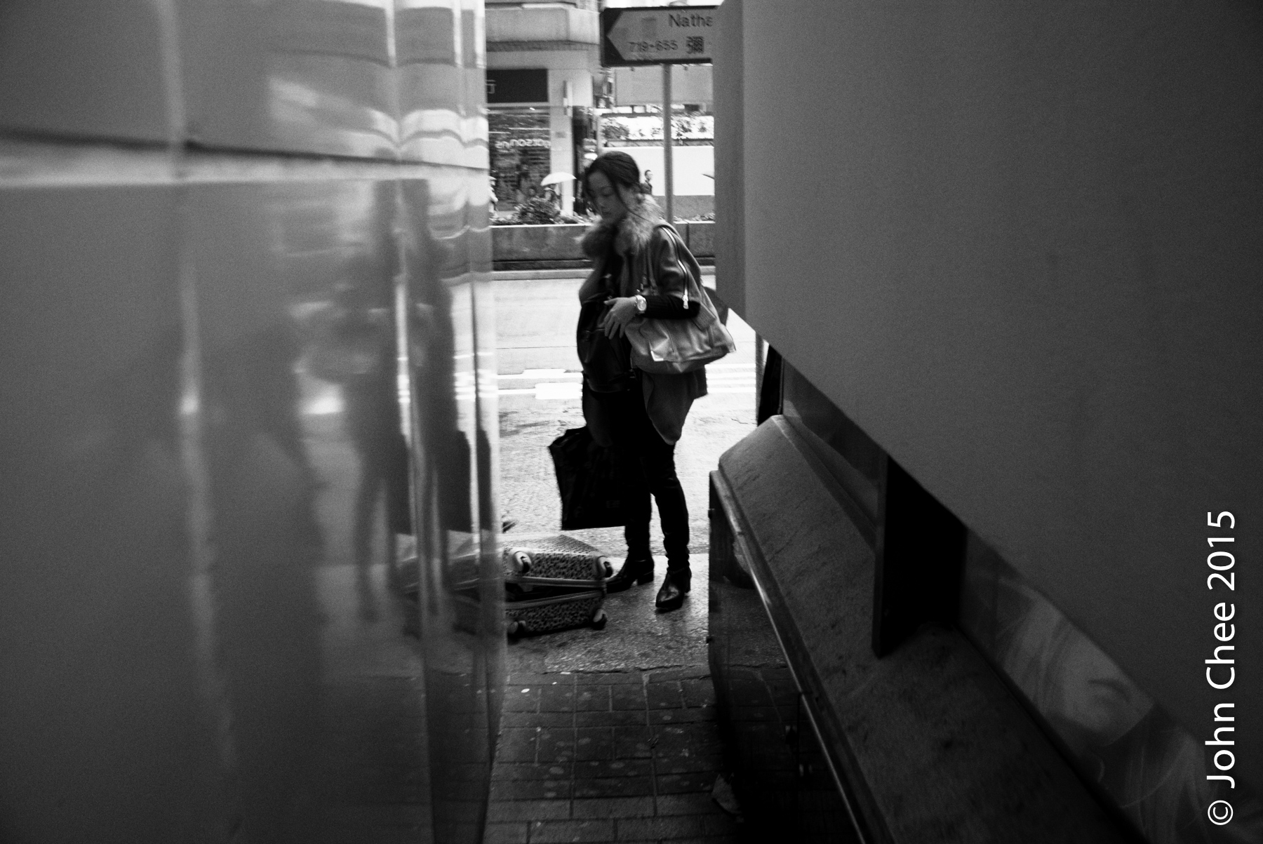 Smugglers (known as the "suitcase gangs") organizing their goods in suitcases by the entrance of the MTR (subway) (Mong Kok, Hong Kong)