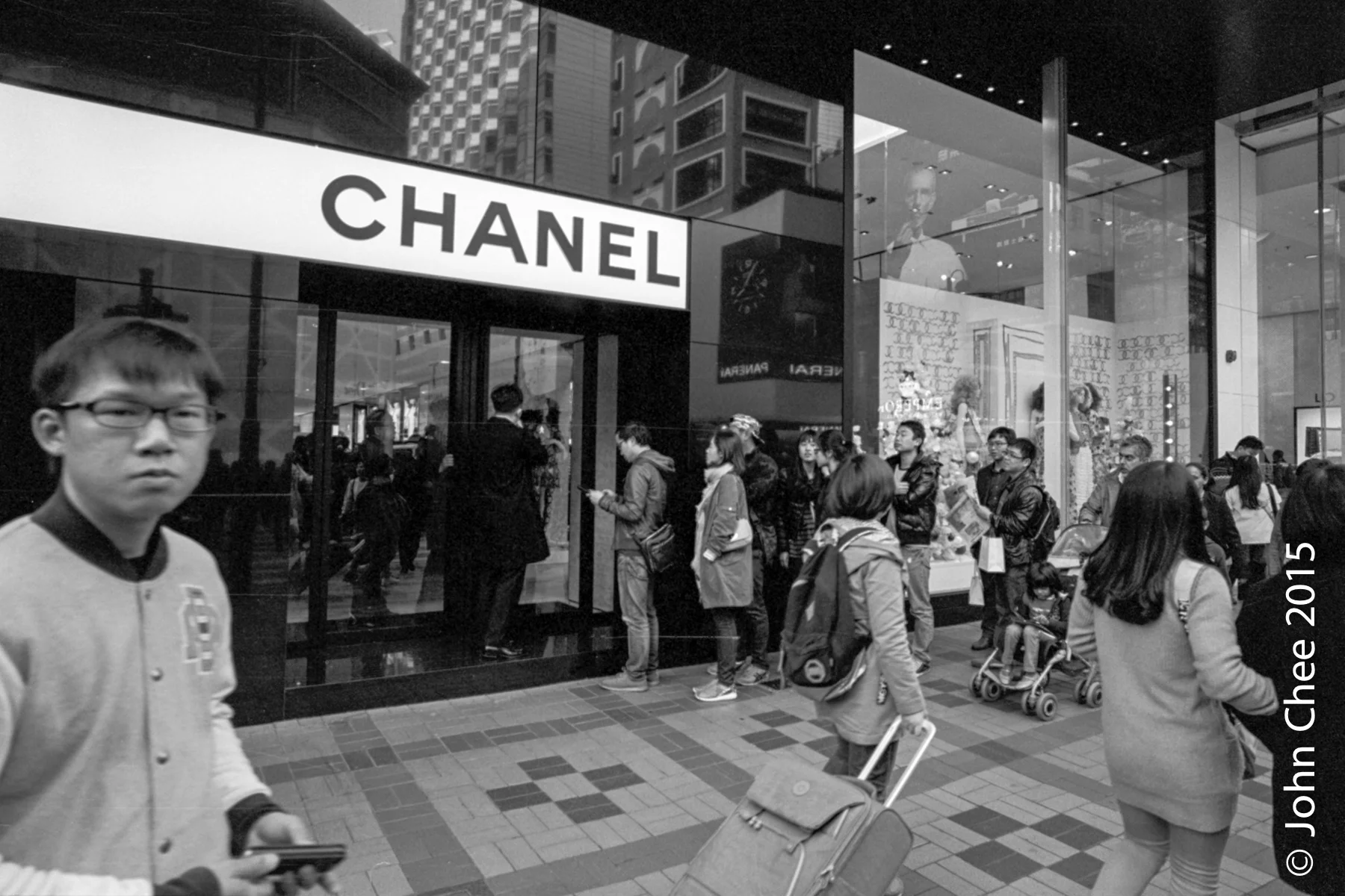 High end shopping districts are overwhelmed by shoppers from China. Most main brand stores ask shoppers to wait in line before entering their stores. (Sham Sha Tsui, Hong Kong)