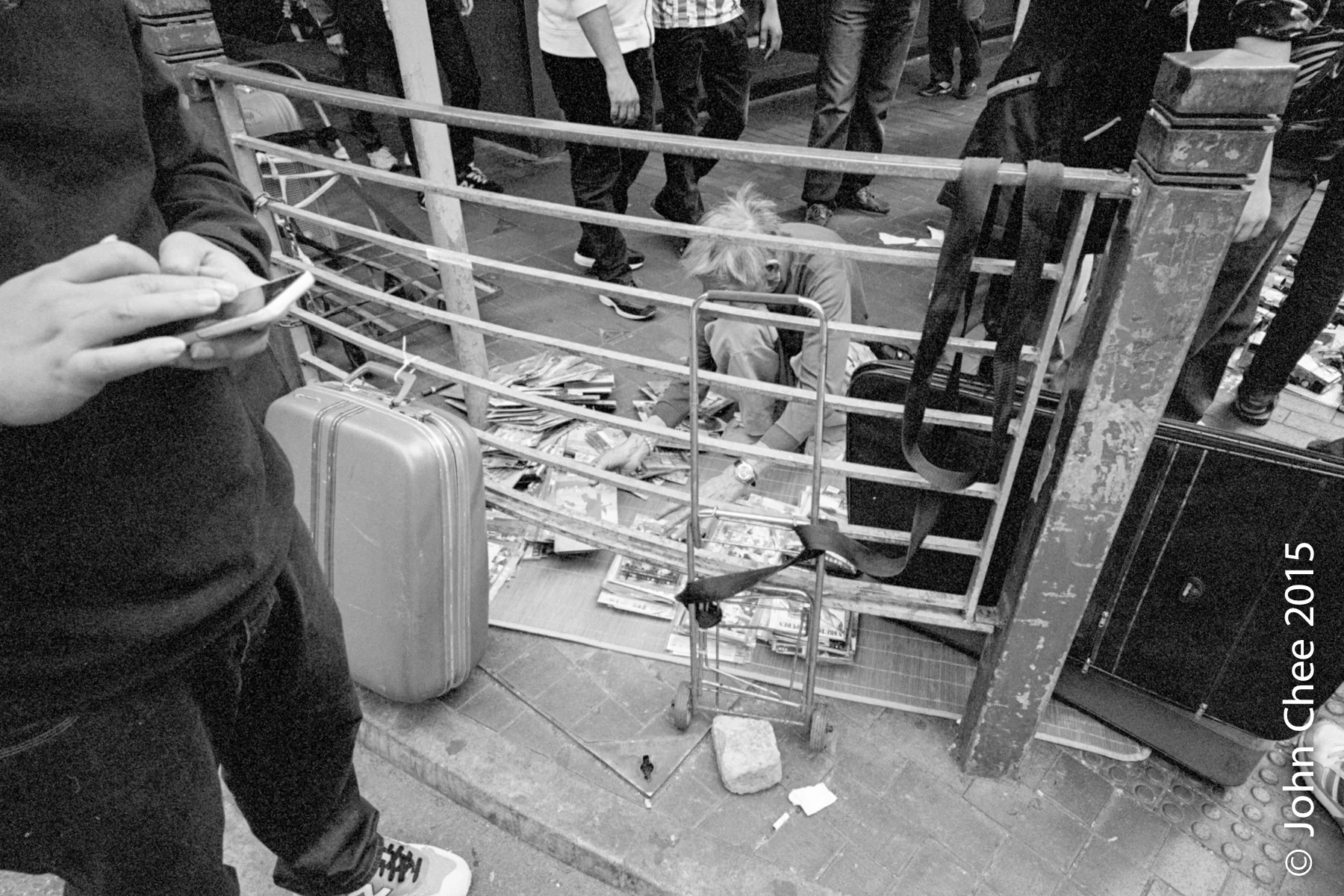 A senior citizen selling old DVDs on the street. Elderly poverty is on the rise while government subsidies is extremely limited. (Mong Kok, Hong Kong)