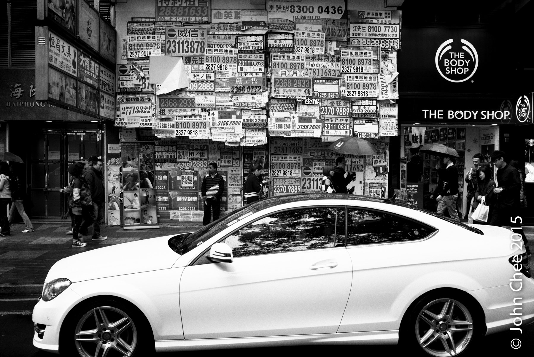 A victim of the high rent in Hong Kong. Emptied retail space with real estate ad covering its door front (Tsim Sha Tsui, Hong Kong)
