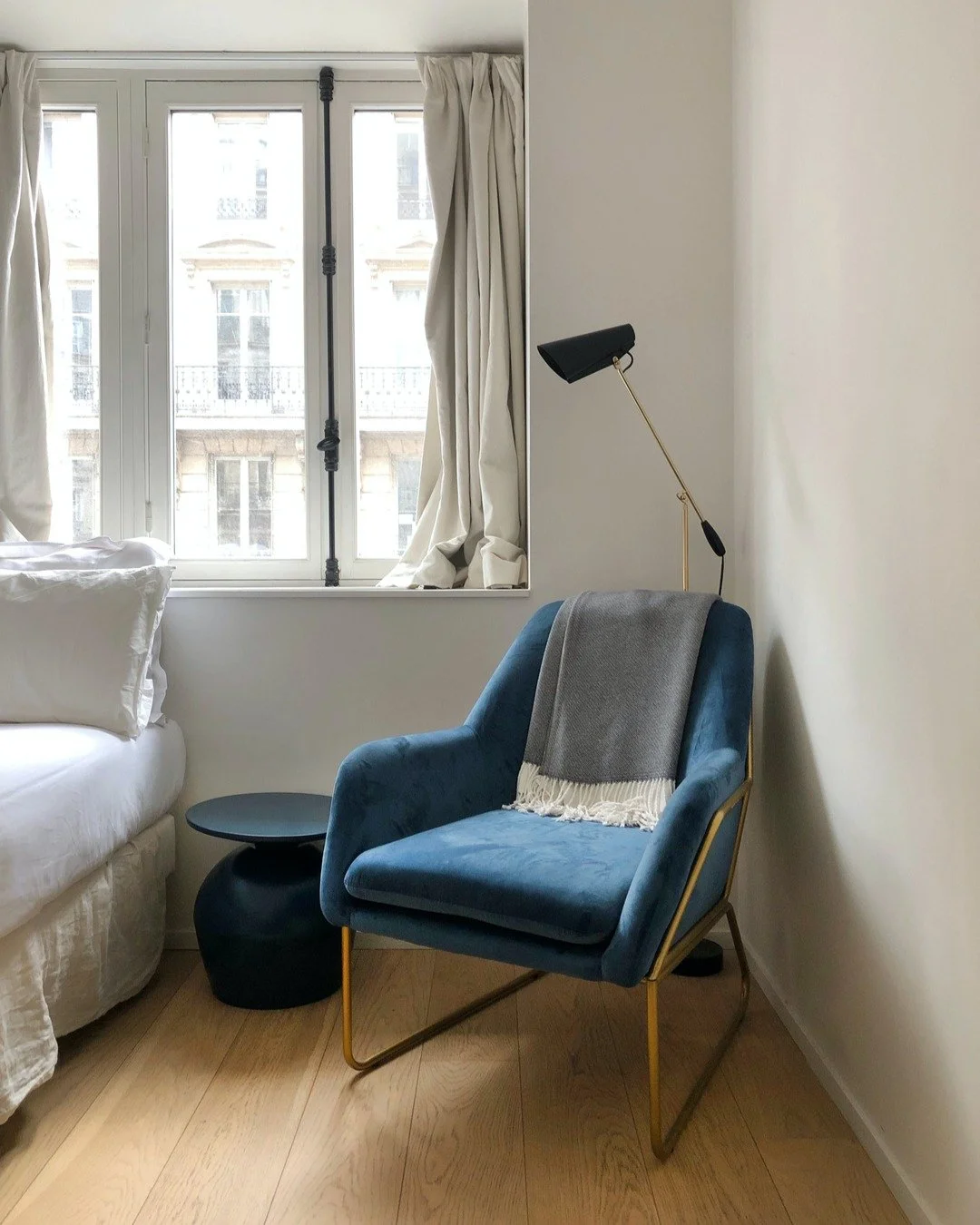 Things I love about this space: the linen in the curtains, the velvet of the chair, the metallic chair legs, the oak floors, and the classic &lsquo;Birdy&rsquo; floor lamp.

Birdy is a lamp series designed in 1952, in a modernist style. The lights we