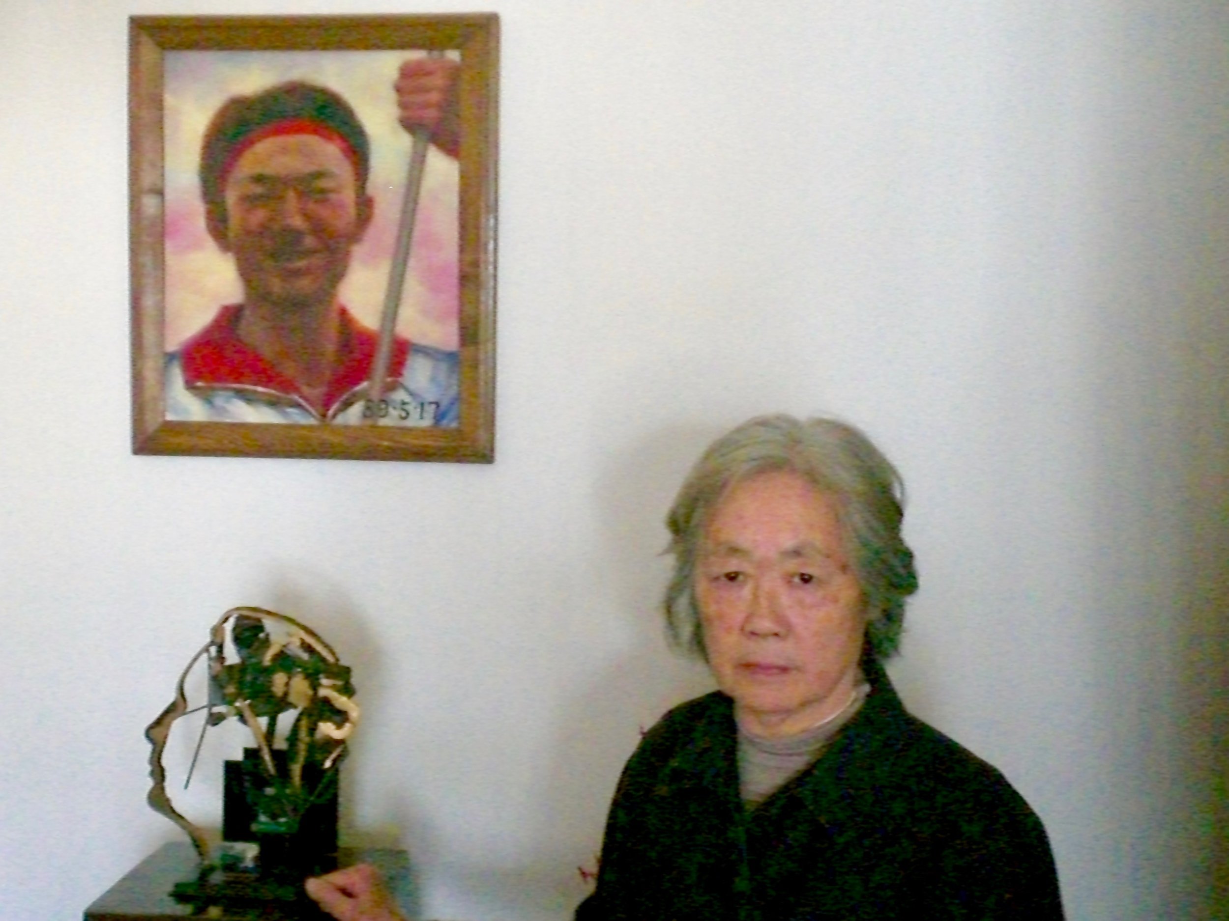 Ding Zilin in front of a portrait of her son Jiang Jielian. (C) Remko Tanis