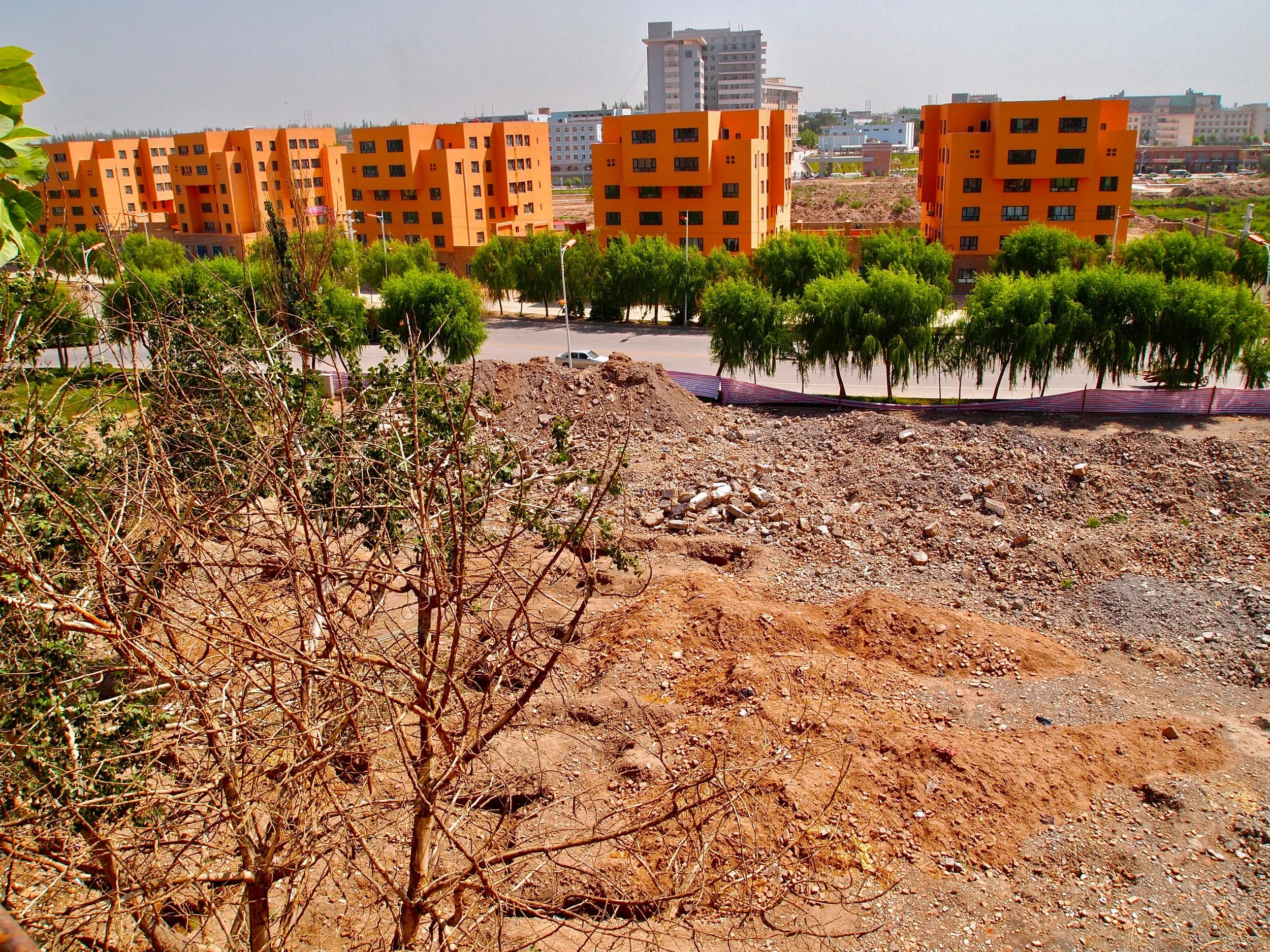 New apartment blocks bordering a demolished part of old Kashgar, Xinjiang, China. (C) Remko Tanis