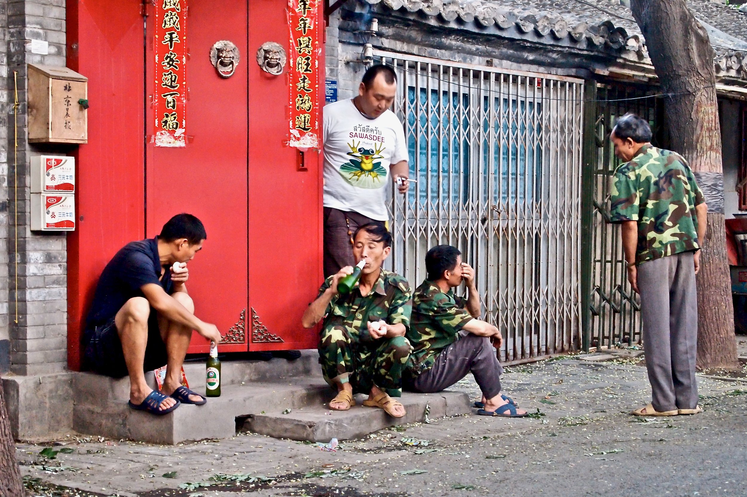 Men drinking a beer in Beijing, China. (C) Remko Tanis