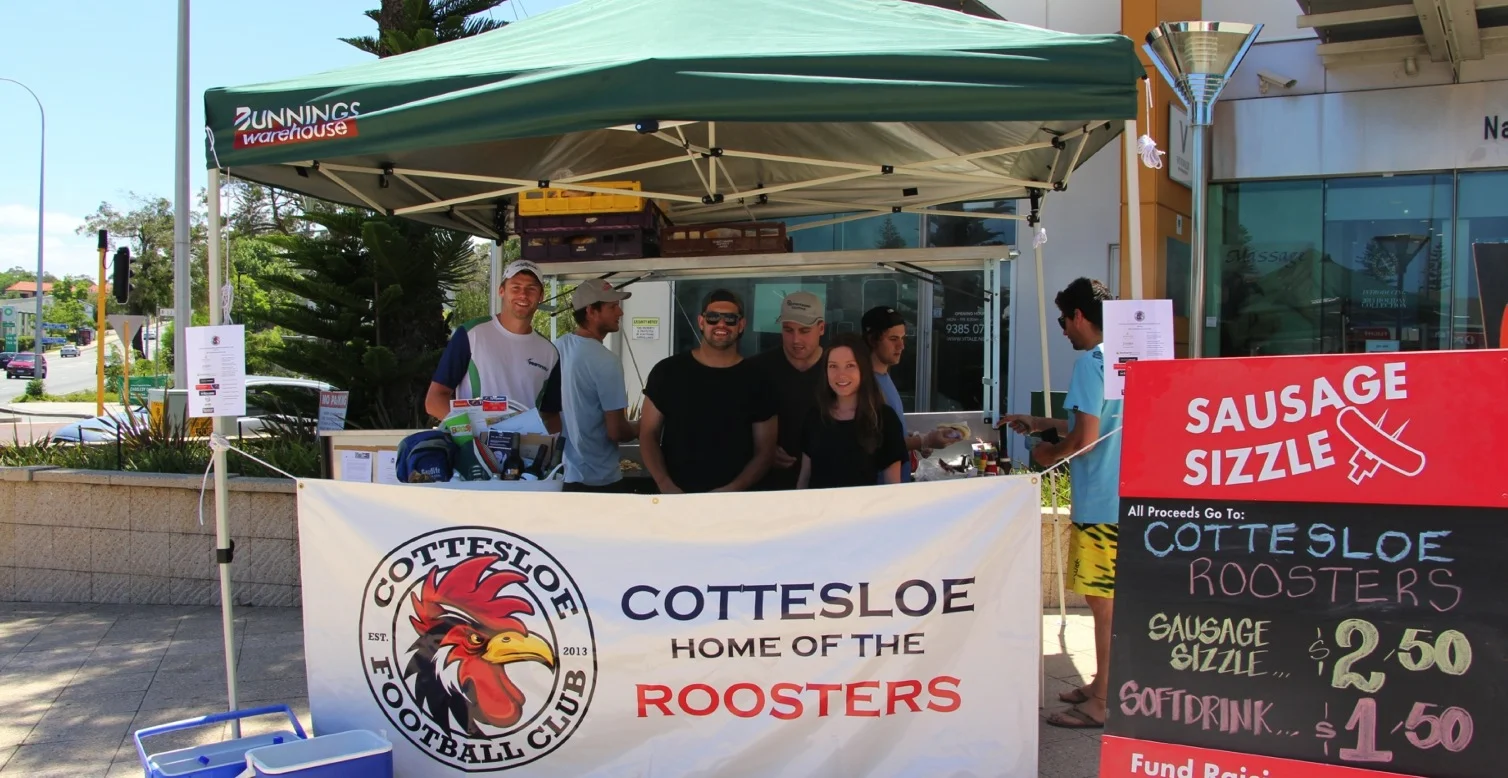 Pictured: Roosters members and volunteers at the Club's fundraising sausage sizzle.
