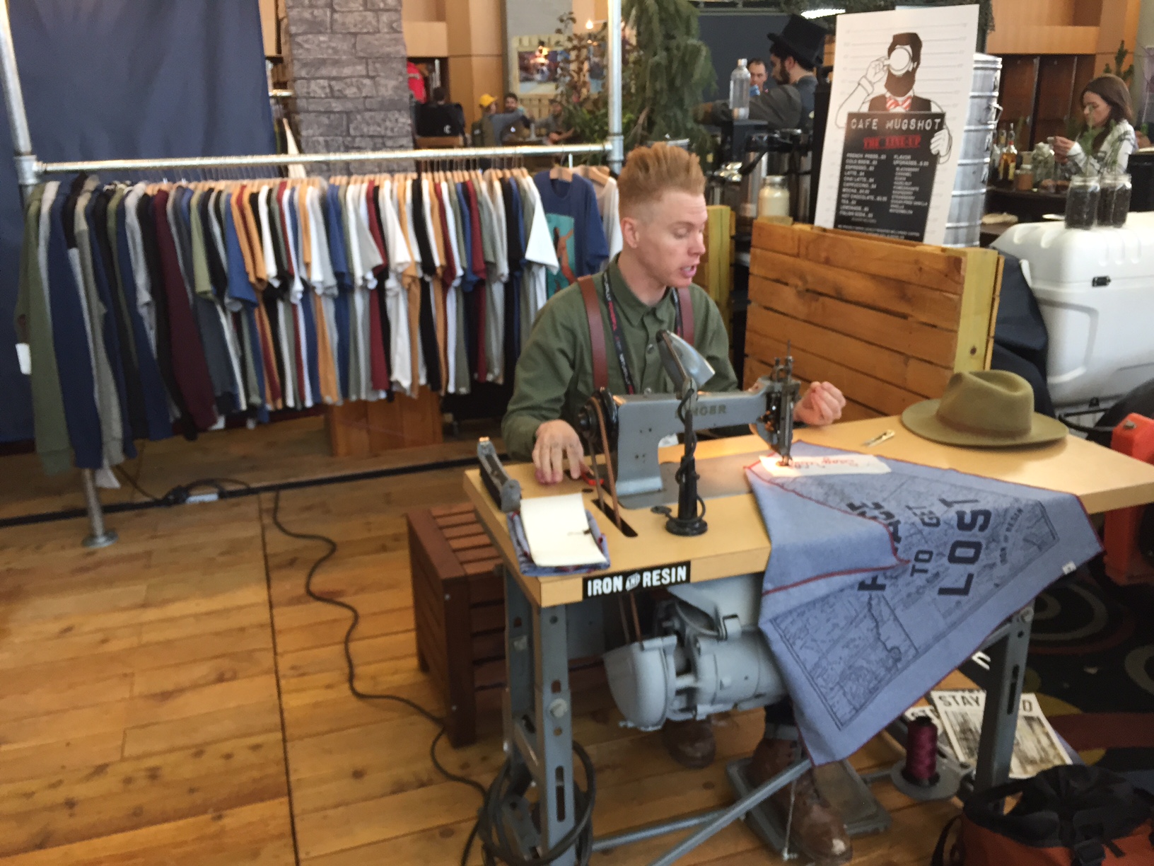 Tommy from Iron and Resin sewed words into bandanas for folks on the spot.
