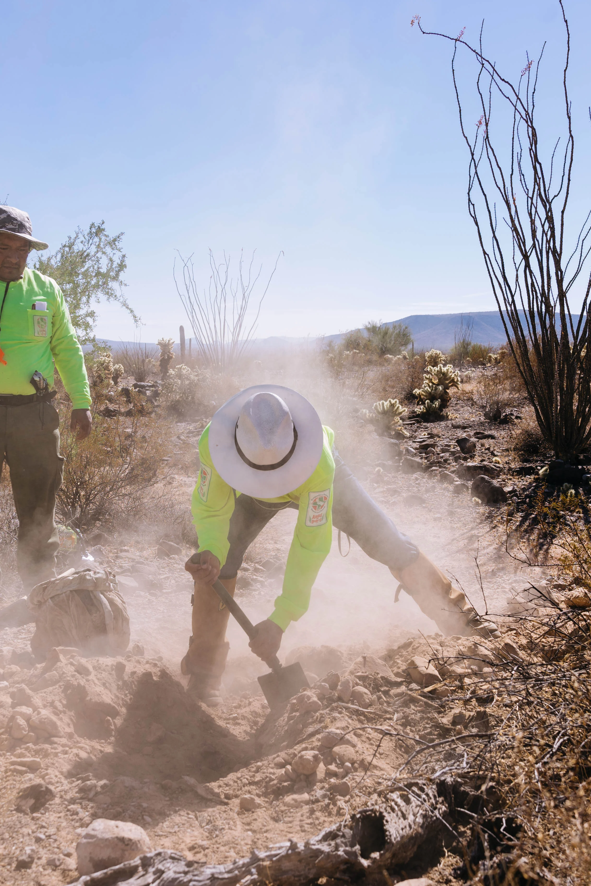 Members of Aguilas Del Desierto dig in the Sonoran Desert where they suspect the body of a migrant has been buried in a shallow grave. Most migrants who die crossing this treacherous desert have been left behind by their guides and quickly succumb to dehydration.
