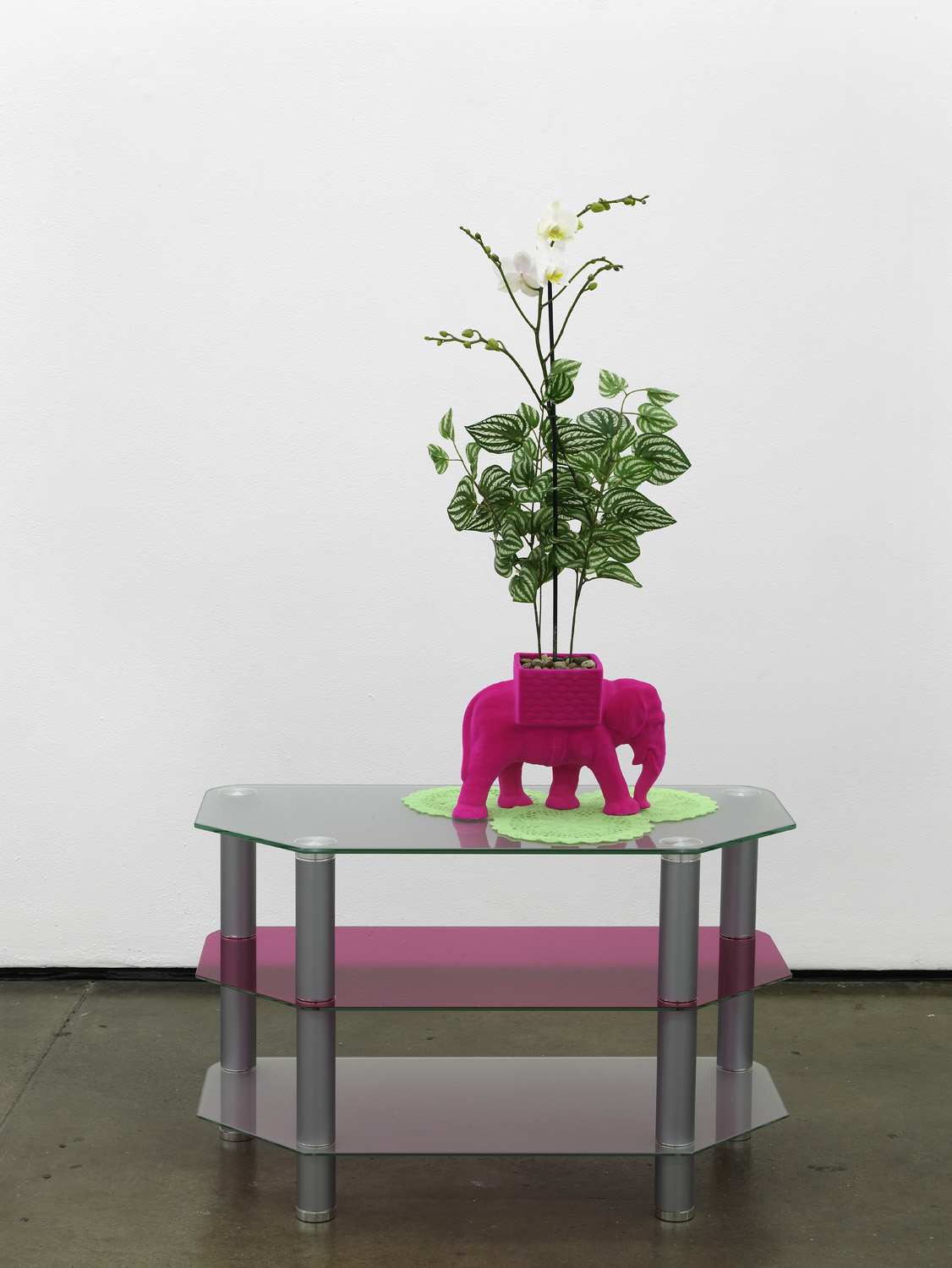     Matthew Darbyshire Untitled Homeware No. 14 2011 fuchsia flocked elephant planter, lime flocked doilies, artificial orchid, coloured glass gels, &nbsp;glass and steel support:&nbsp;140 x 80 x 40 cm 