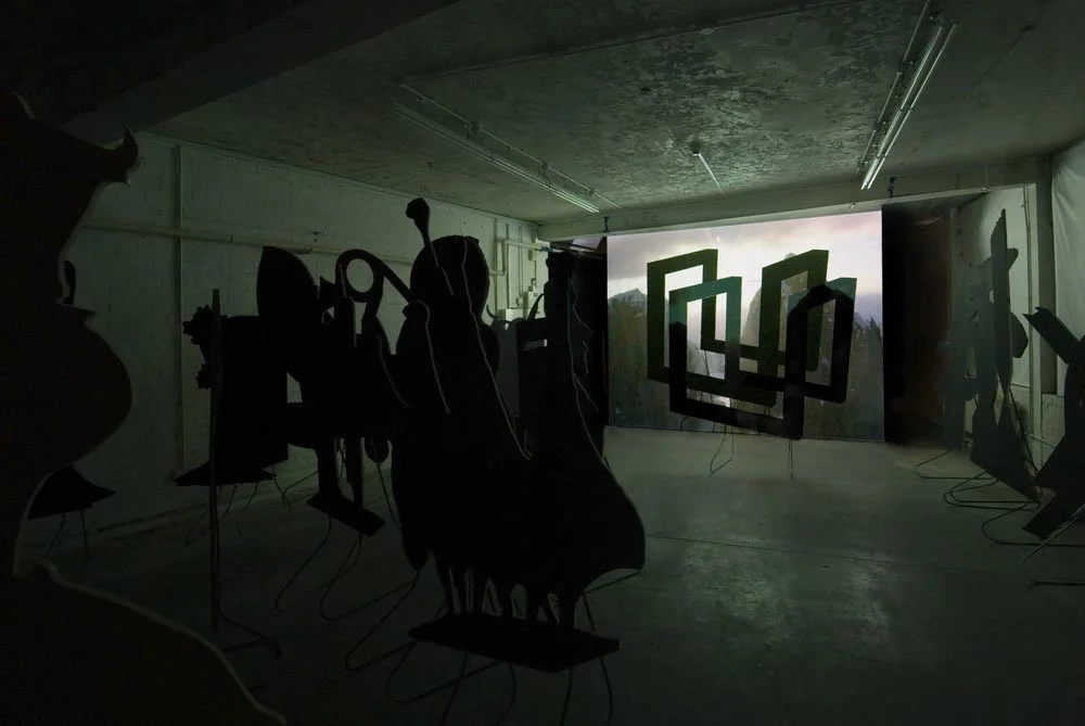 Around, About Expanded Field Installation View 2007 Projection, MDF, Paint, Steel stands