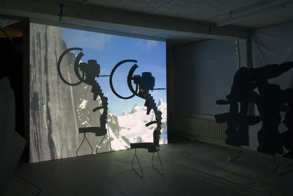 Around, About Expanded Field Sculpture Silhouette Props: (J. Tinguely 'Variation IV' 1966) 2007 Projection, MDF, Paint, Steel stands