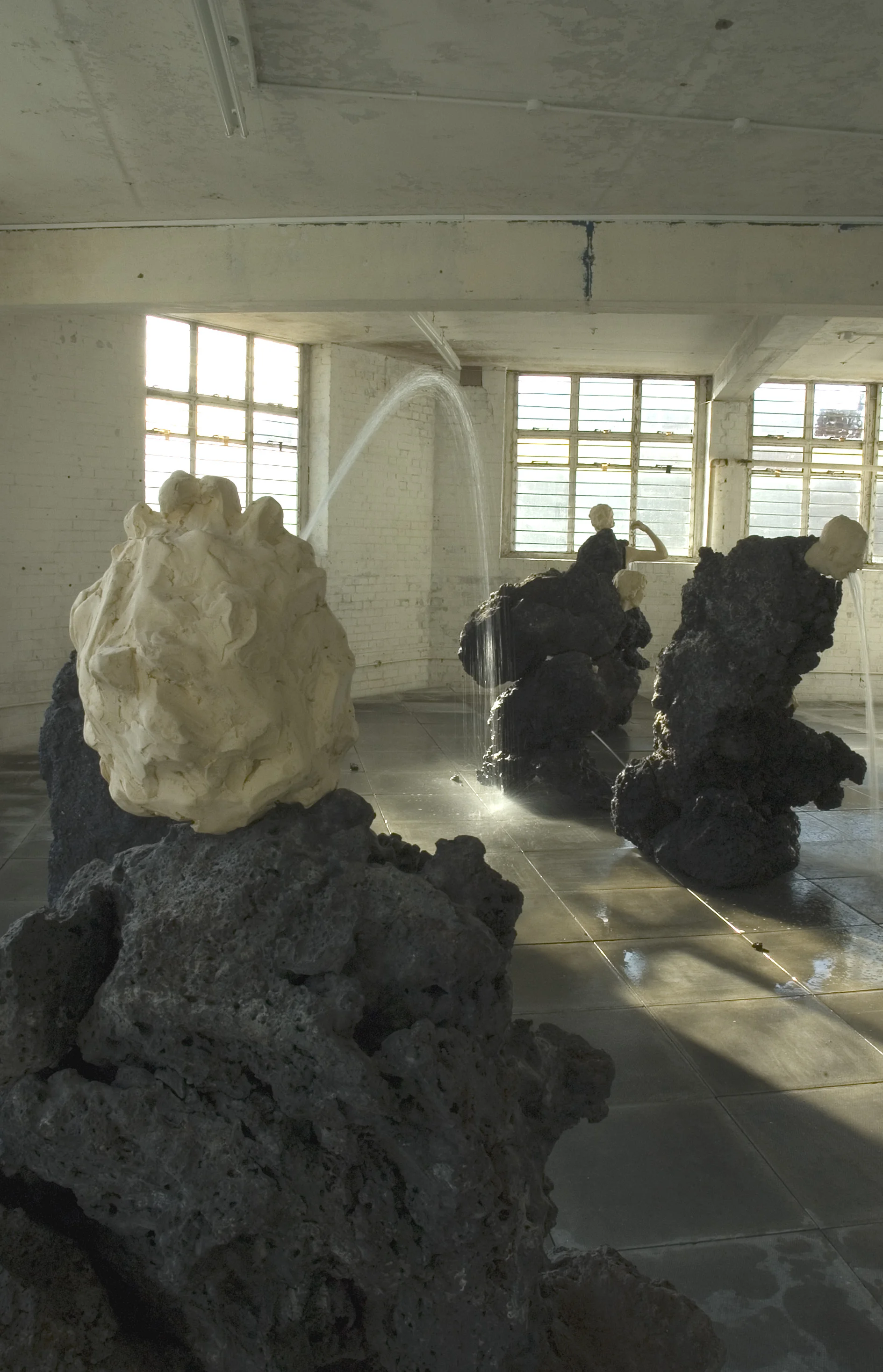 The Big Giving (small group) 2006 Scoria, Resin, & Water Dimensions Variable