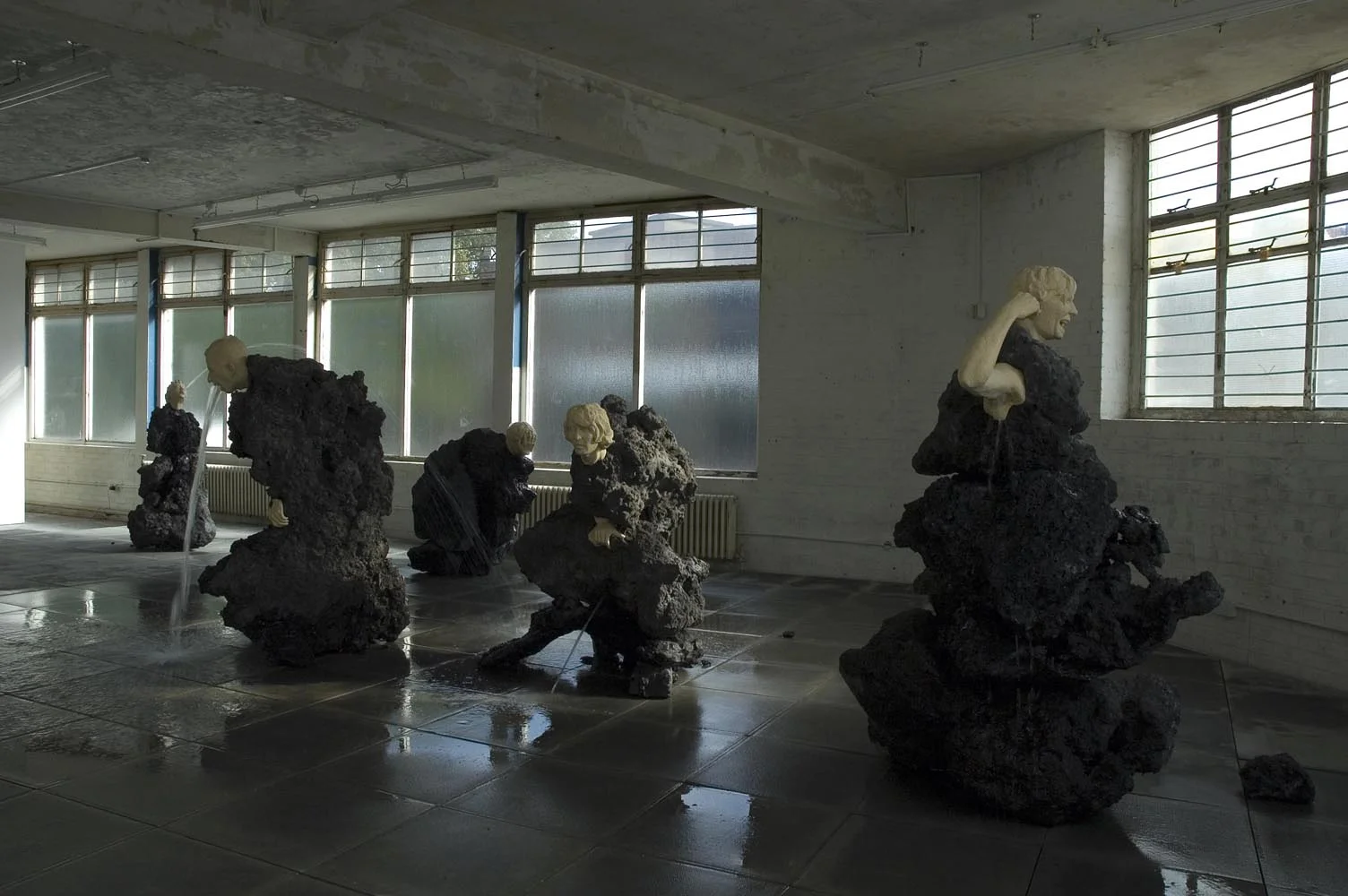 The Big Giving (small group) 2006 Scoria, Resin, & Water Dimensions Variable