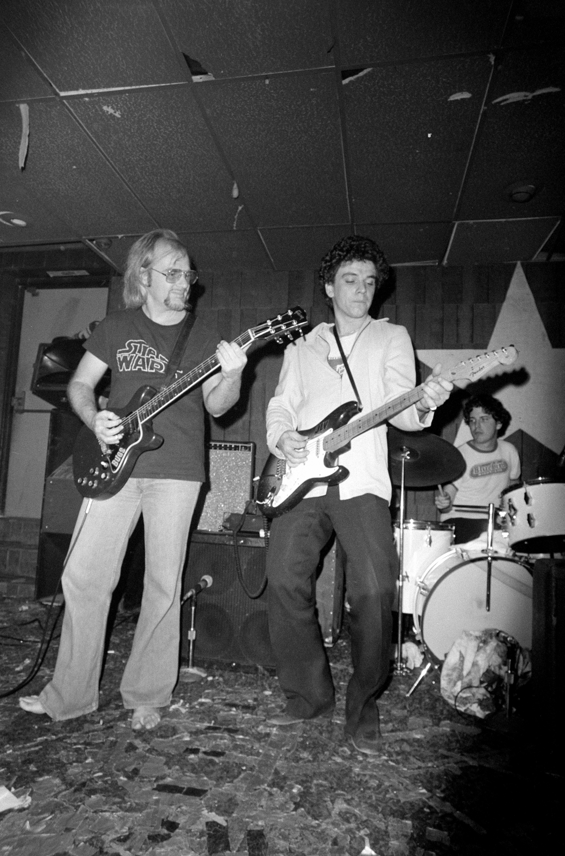 Bugs Henderson and Jimmie Vaughan, at Sneaky Pete's in Medallion Center, Dallas, TX, in 1977. That's Mike Buck on the drums.
