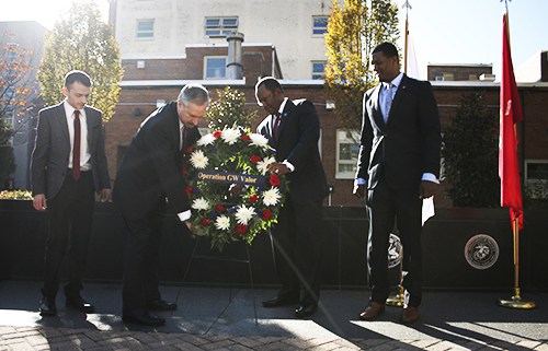Student Association President Nick Gumas, Provost Steven Lerman, Associate Provost for Military and Veterans Affairs Mel Williams and GW Veterans President Emanuel Johnson place a wreath in front of the wall of Veterans Memorial Park. Nicole Radivilov | Assistant Photo Editor