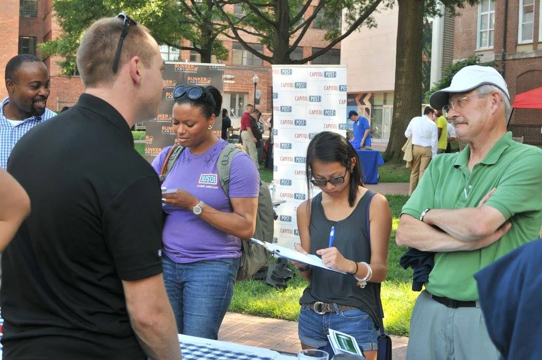 GW Veteran Yannick Baptiste speaking with new students and their parents at the 2016 GW VALOR Tailgate