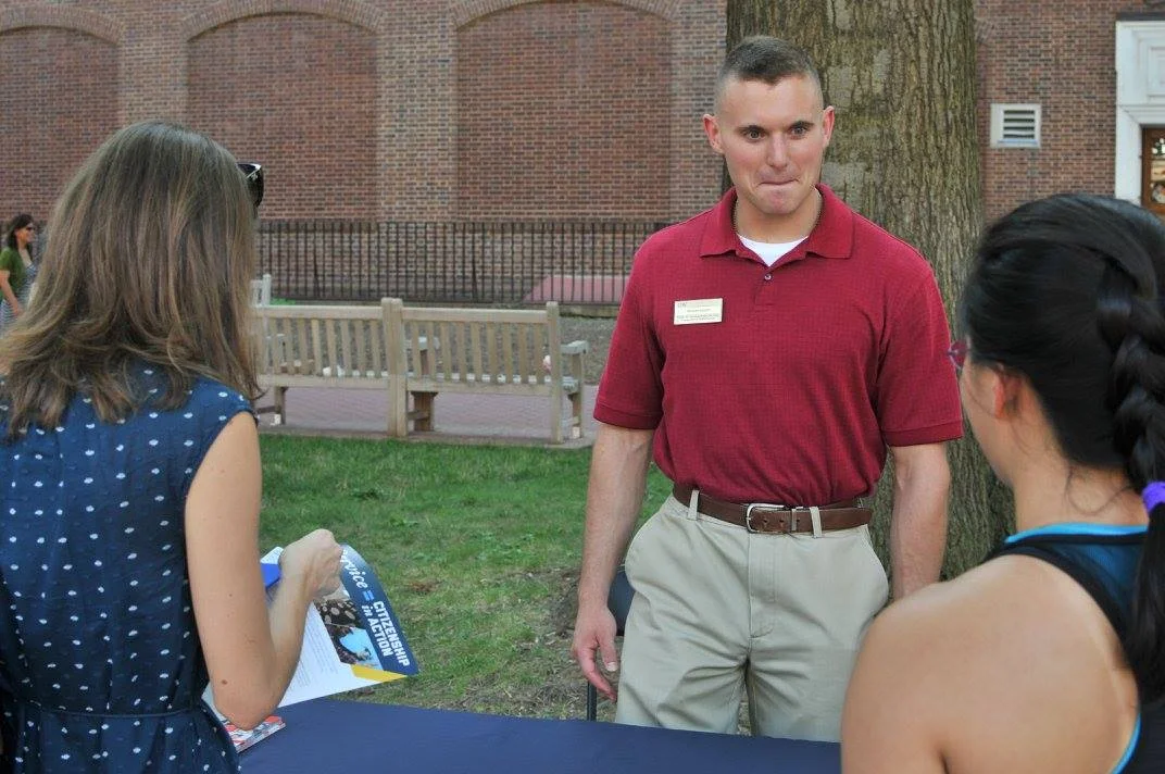 GW Veteran Matt Basista speaking with students about GW Veteran Service Initiative under the Honey W. Nashman Center for Civic Engagement and Public Service at the the 2016 GW VALOR Tailgate.