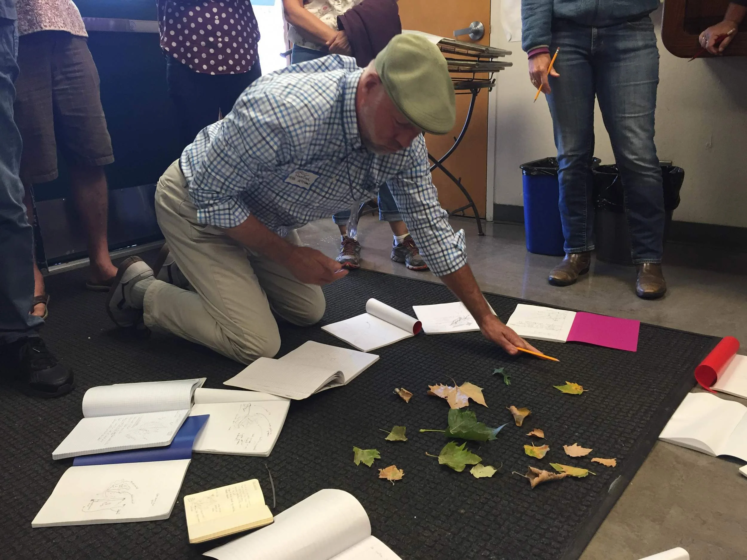 McNear Elementary teacher Eric Norstad plays a field journaling game, matching leaves to peers' drawings and descriptions.