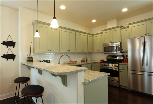 Custom painted kitchen cabinets, breakfast bar, and SS appliances