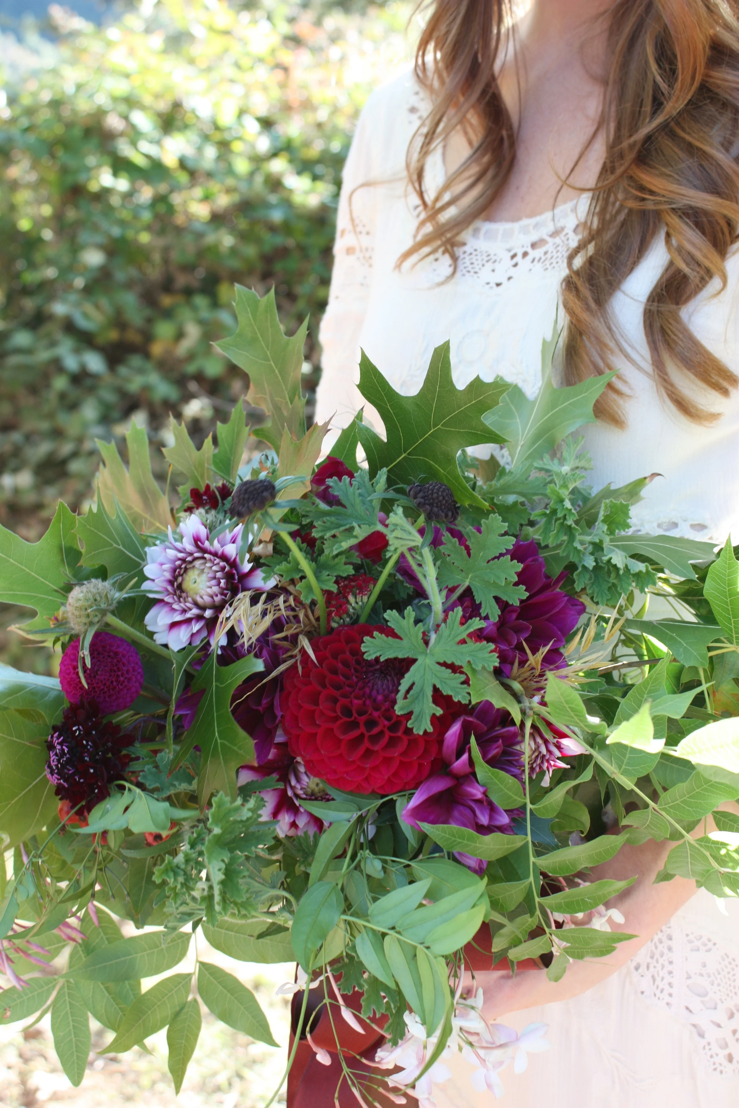 Marisa's Ranch wedding bouquet was a loose mix of all local organic blooms and foliage. Include were five different varieties of dahlias, scabiosa, pods and blooms, sweet smelling jasmine, and geranium and finished with oak leaves, Chinese pistache leaaves and grasses.