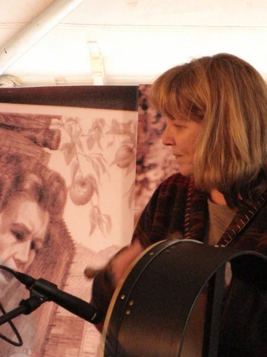 Playing on stage at the Home Crafts Day Festival at Mountain Empire Community College. That's a drawing of Janette Carter, daughter of A.P and Sara Carter, behind me; I spent a lot of time at her house when I was a little girl. The drawing is by Willard Gayheart, the artist who drew the cover of HIDING EZRA. You can read more about him at the link to his website listed under the HIDING EZRA -COVER section on the sidebar.
