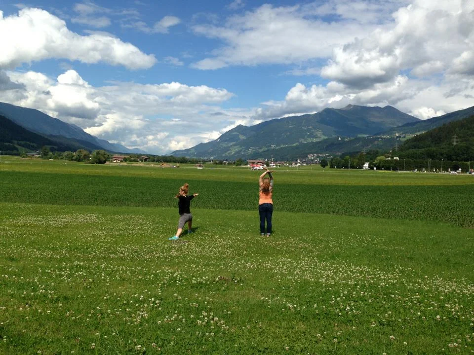 My friend Caroline and I doing sun salutations in front of the Austrian Alps this summer. 