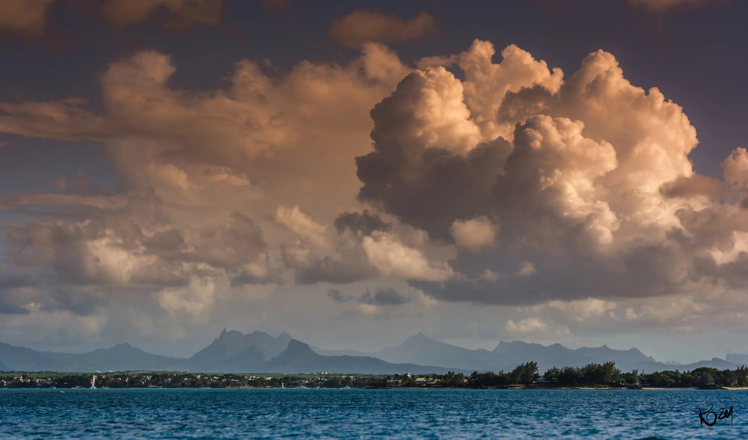 Heading home after a lazy Sunday with good friends. Grand Bay, with the mountains of Mauritius in the distance.