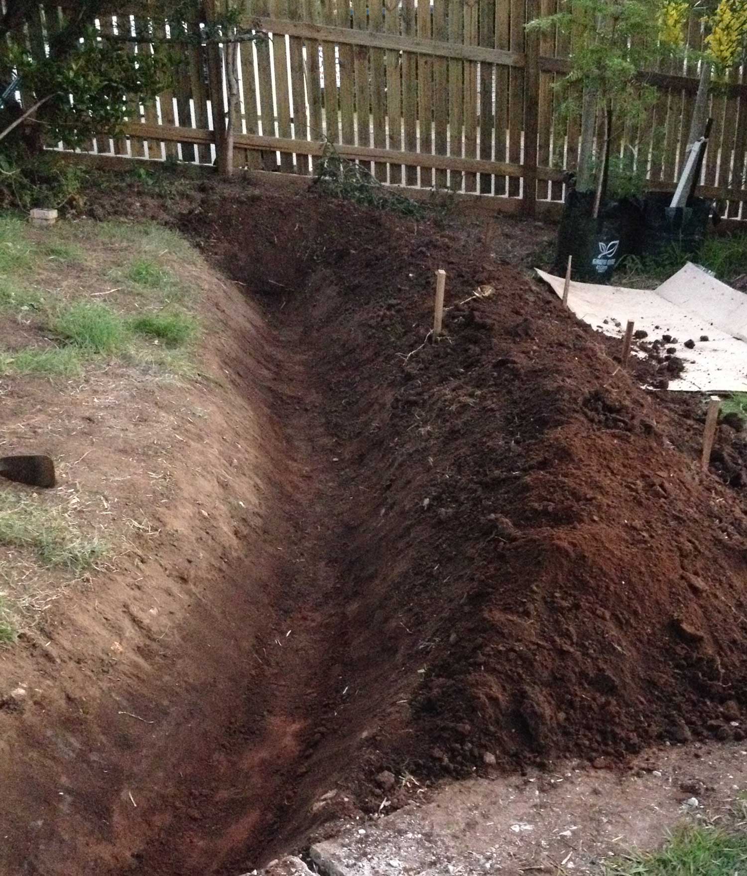 Contour swale under construction. Trench on left and berm on downslope side (right).