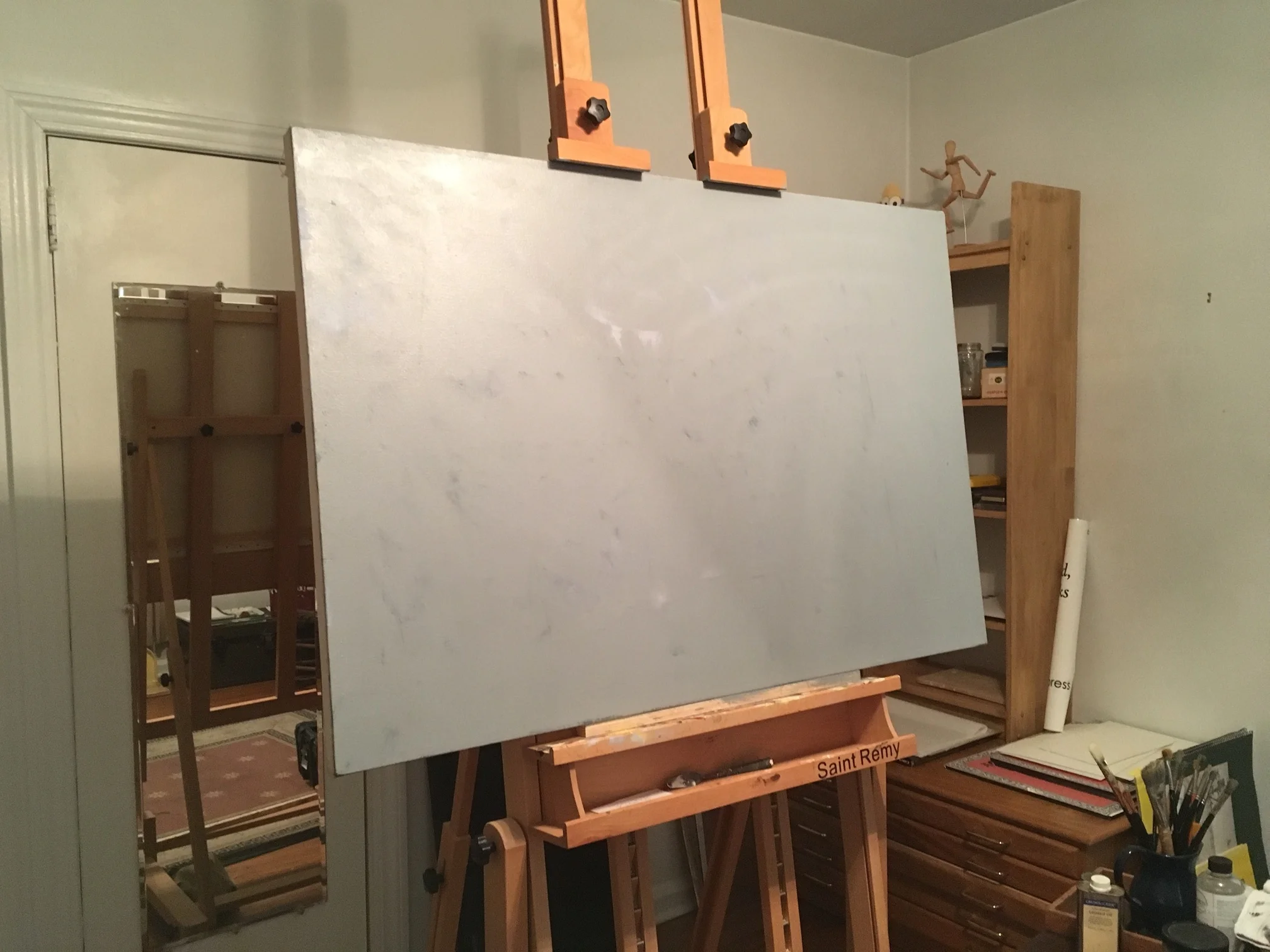 Underneath this grey oil ground is the beginnings of another oil painting I lost interest in, and below that is an acrylic polymer painting of a house at sunset with huge billowy clouds behind, which I simply hated.