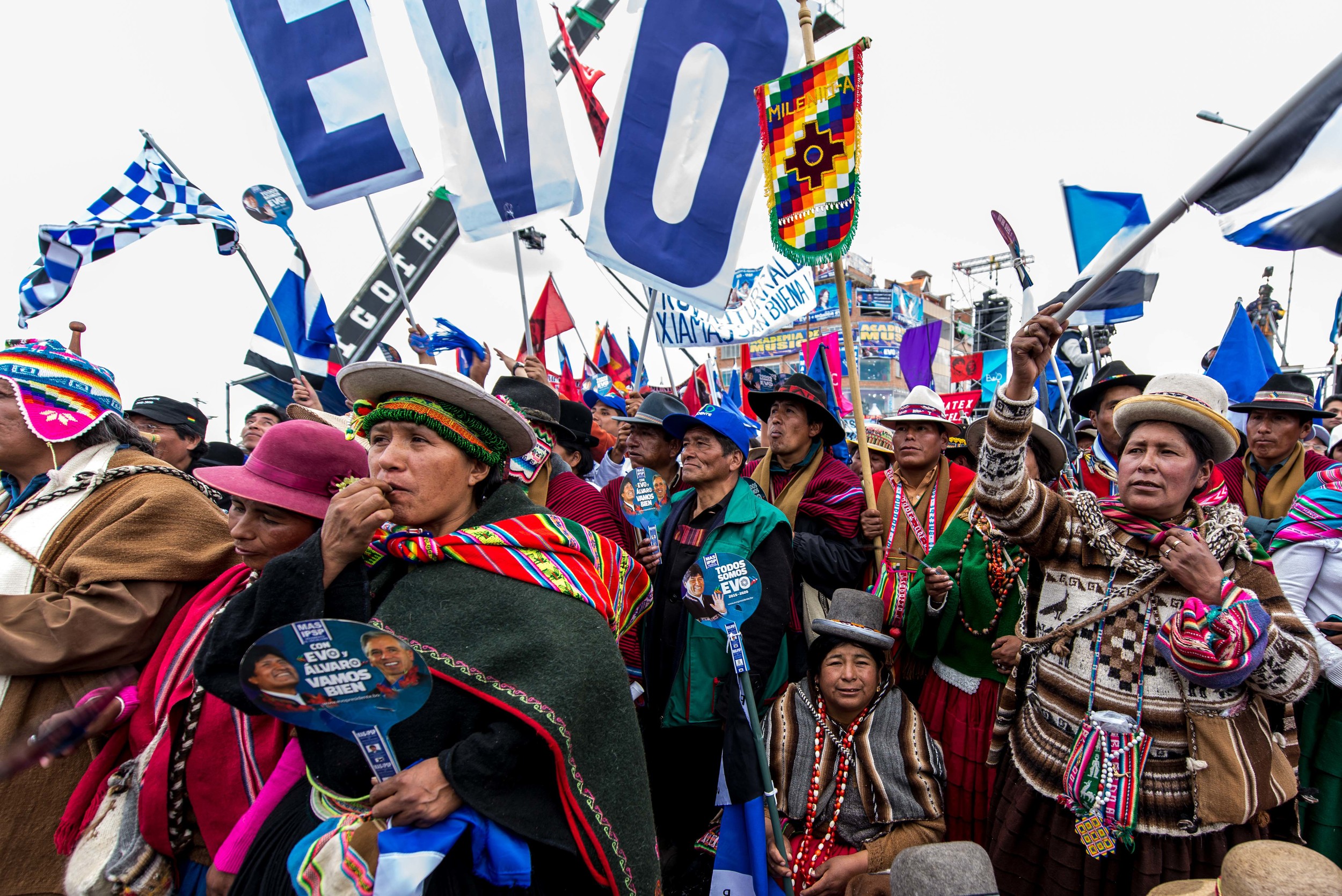 Tens of thousands of people wave blue, white and black chequered flags, the colours of MAS (Movimiento Al Socialismo), Morales' party. In 2005, Evo Morales became the first indigenous president in Bolivia. Many cholitas, indigenous women, admi