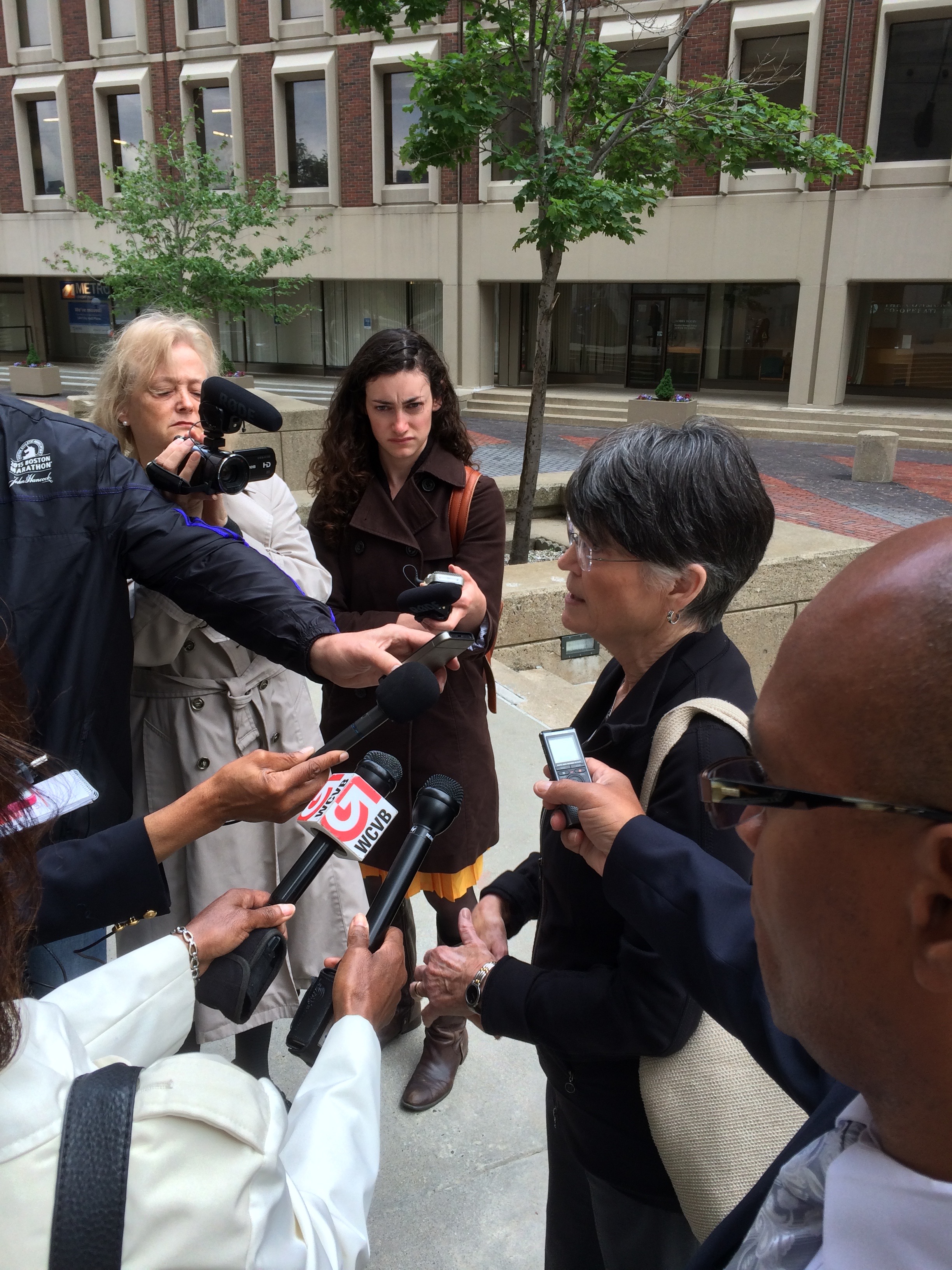 Elaine Murphy speaking to the press outside Boston's Suffolk County Courthouse after Sean Ellis's release on bail on June 3, 2015.