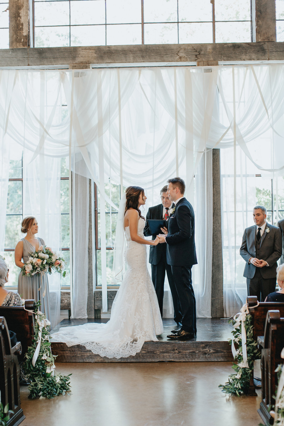 Exchanging Vows during the ceremony- all florals by Maxit Flower Design