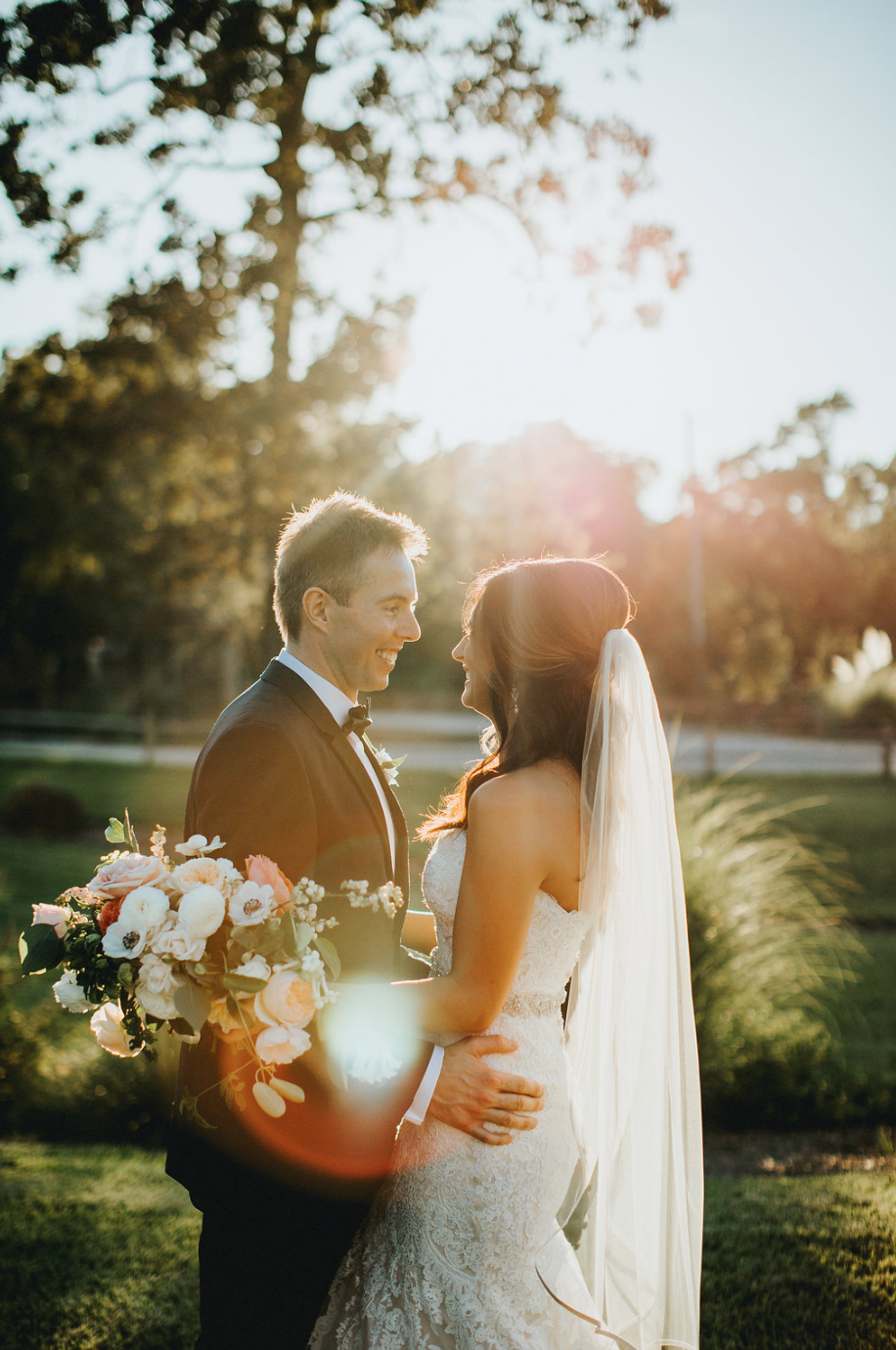 The perfect lighting shining on the newlyweds. Bridal Bouquet by Maxit Flower Design in Houston, TX.