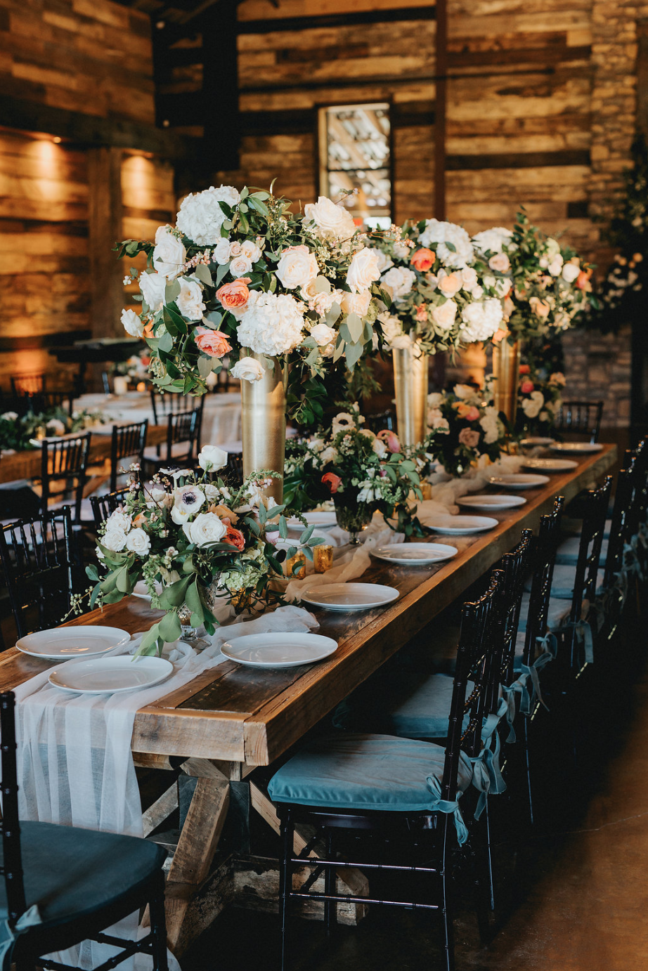 Wooden table with mixed heights arrangements by Maxit Flower Design in Houston, TX