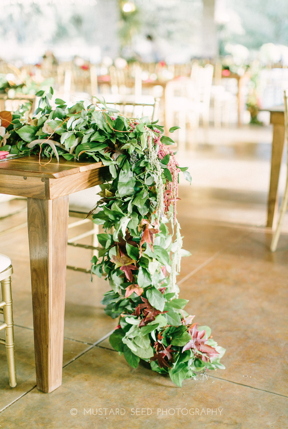 Floral Garland on a wooden table at Houston Oaks Country Club by Maxit Flower Design in Houston, TX.
