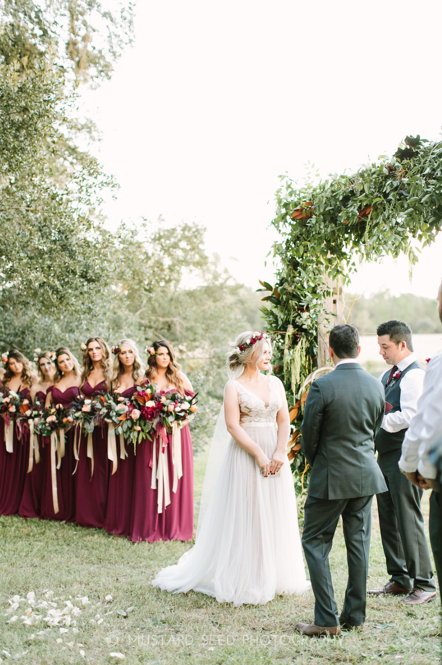 Our bride with her bridesmaids watching her marry the love of her life. All flowers and arch by Maxit Flower Design in Houston, TX.